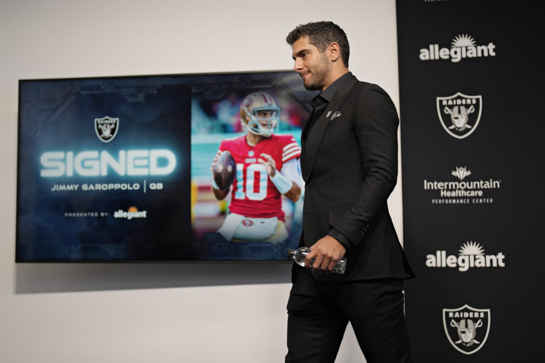 Las Vegas Raiders quarterback Jimmy Garoppolo walks away after taking questions at an NFL football news conference Friday, March 17, 2023, in Henderson, Nev. (AP Photo/John Locher)