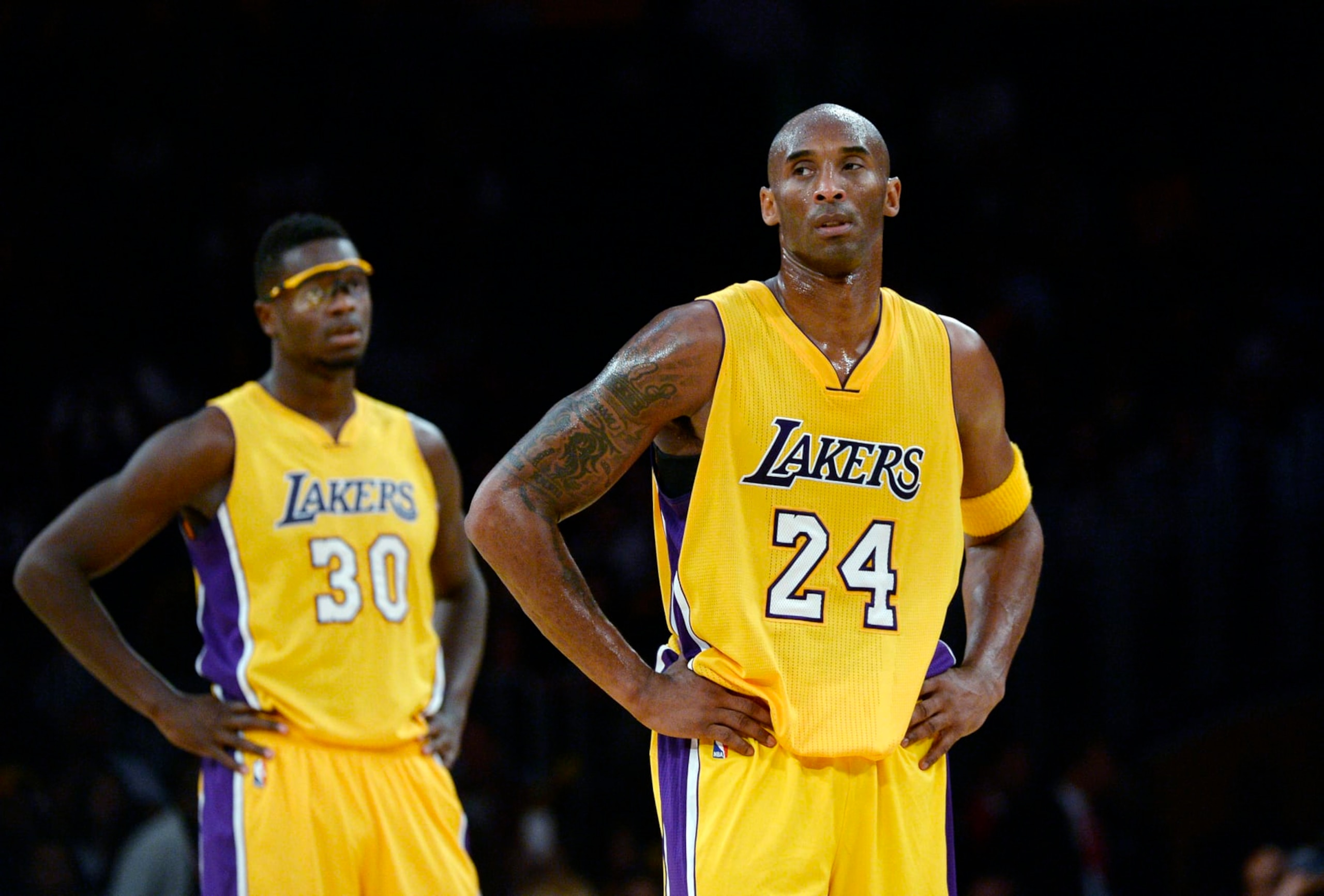 LOS ANGELES CA - NOVEMBER 3: Kobe Bryant #24 and Julius Randle #30 of the Los Angeles Lakers during a break in the action against Denver Nuggets in the fourth quarter of the basketball game at Staples Center November 3, 2015, in Los Angeles California. Lakers lost to the Nuggets, 120-109. NOTE TO USER: User expressly acknowledges and agrees that, by downloading and or using this photograph, User is consenting to the terms and conditions of the Getty Images License Agreement. (Photo by Kevork Djansezian/Getty Images)