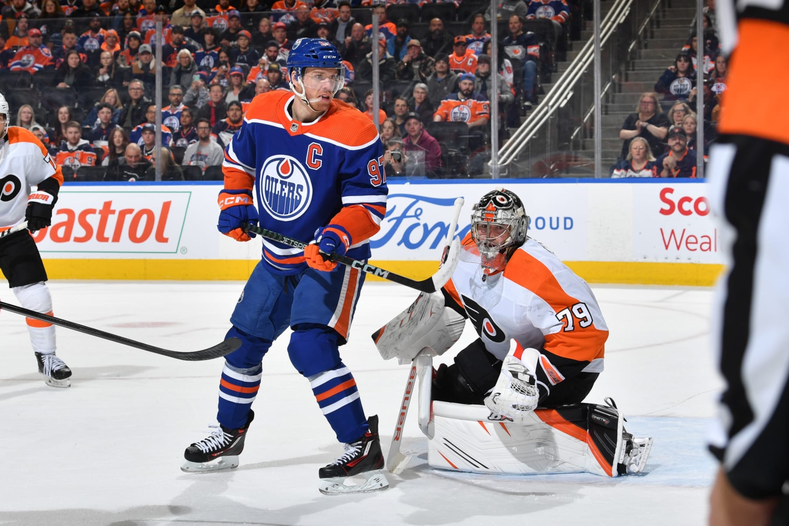 EDMONTON, CANADA - FEBRUARY 21: Connor McDavid #97 of the Edmonton Oilers and Carter Hart #79 of the Philadelphia Flyers track the play during the game on February 21, 2023 at Rogers Place in Edmonton, Alberta, Canada. (Photo by Andy Devlin/NHLI via Getty Images)
