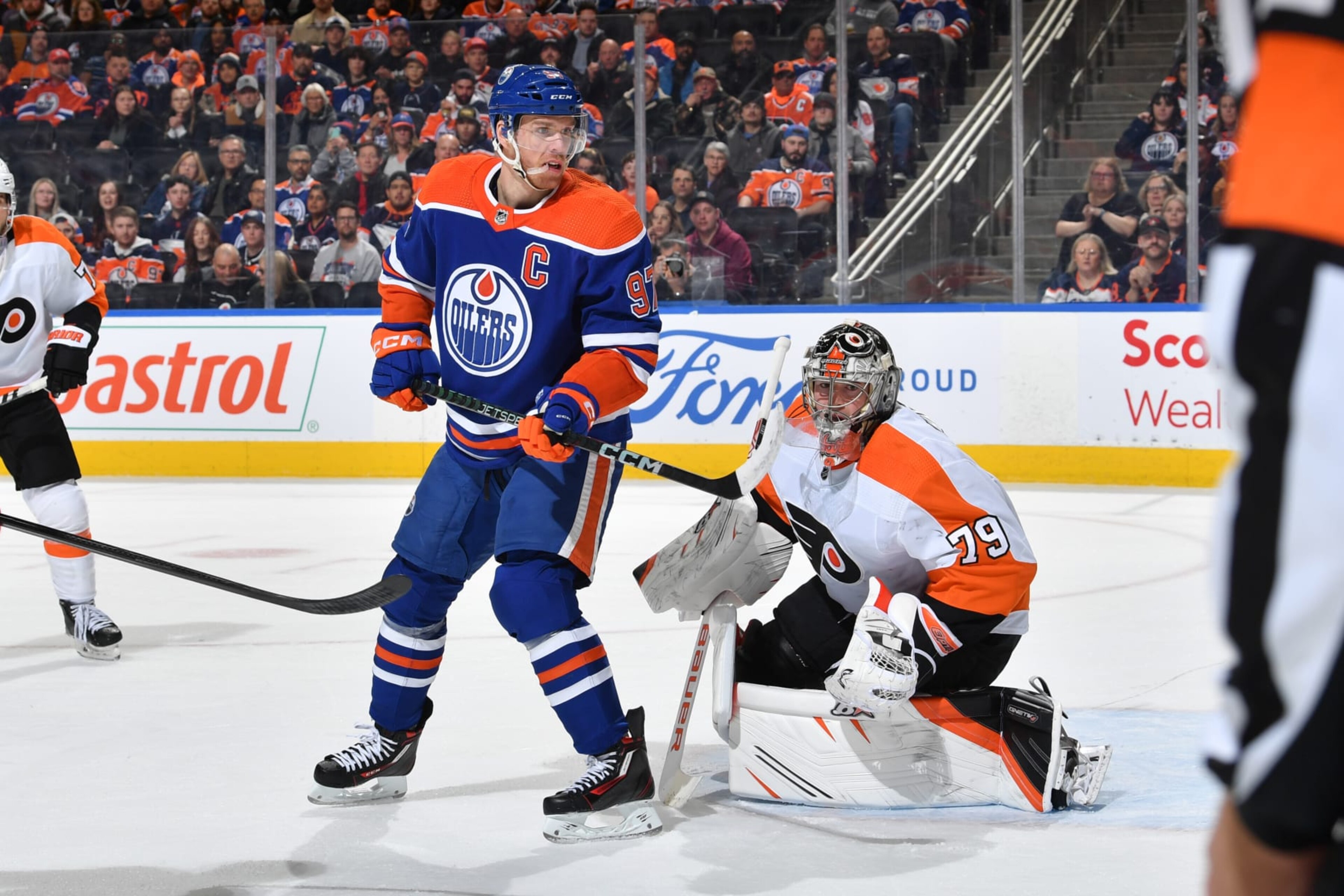 EDMONTON, CANADA - FEBRUARY 21: Connor McDavid #97 of the Edmonton Oilers and Carter Hart #79 of the Philadelphia Flyers track the play during the game on February 21, 2023 at Rogers Place in Edmonton, Alberta, Canada. (Photo by Andy Devlin/NHLI via Getty Images)