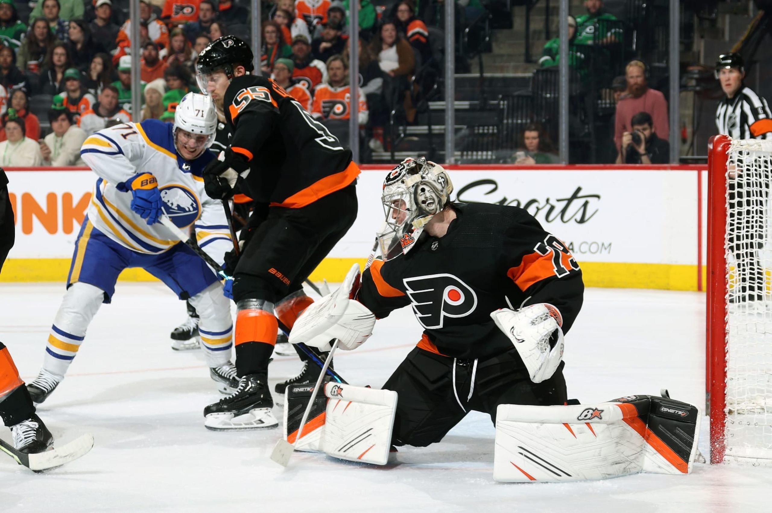 PHILADELPHIA, PENNSYLVANIA - MARCH 17:  Carter Hart #79 and Rasmus Ristolainen #55 of the Philadelphia Flyers battle to defend their goal against Victor Olofsson #71 of the Buffalo Sabres at the Wells Fargo Center on March 17, 2023 in Philadelphia, Pennsylvania.  (Photo by Len Redkoles/NHLI via Getty Images)