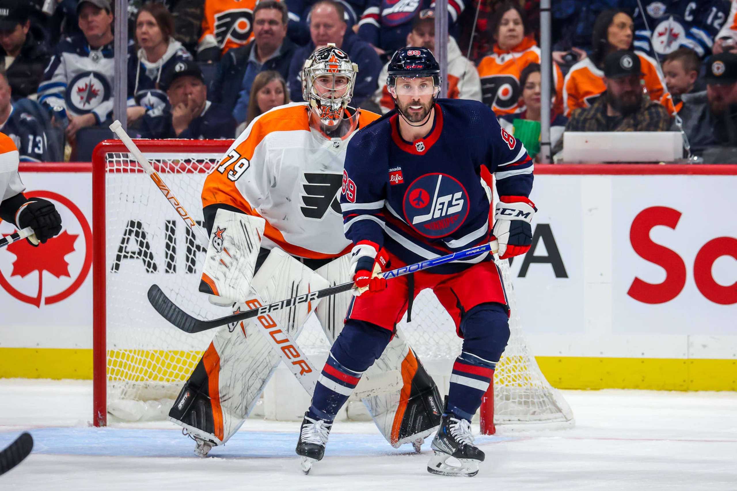 WINNIPEG, CANADA - JANUARY 28: Sam Gagner #89 of the Winnipeg Jets keeps an eye on the play in front of goaltender Carter Hart #79 of the Philadelphia Flyers during third period action at Canada Life Centre on January 28, 2023 in Winnipeg, Manitoba, Canada. (Photo by Jonathan Kozub/NHLI via Getty Images)
