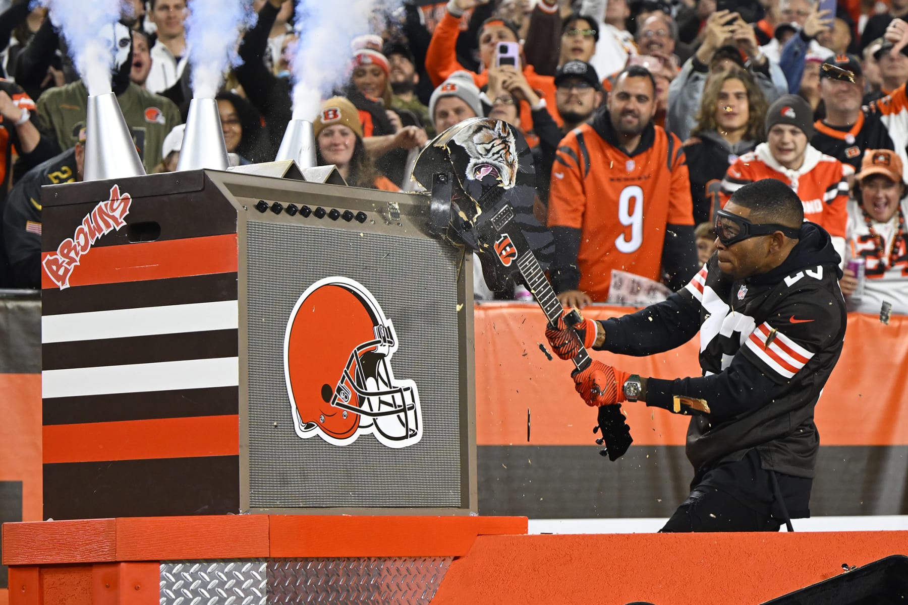 Retired Cleveland Browns Joe Haden smashes a guitar during pre-game activities before an NFL football game between the Cleveland Browns and the Cincinnati Bengals in Cleveland, Monday, Oct. 31, 2022. (AP Photo/David Richard)