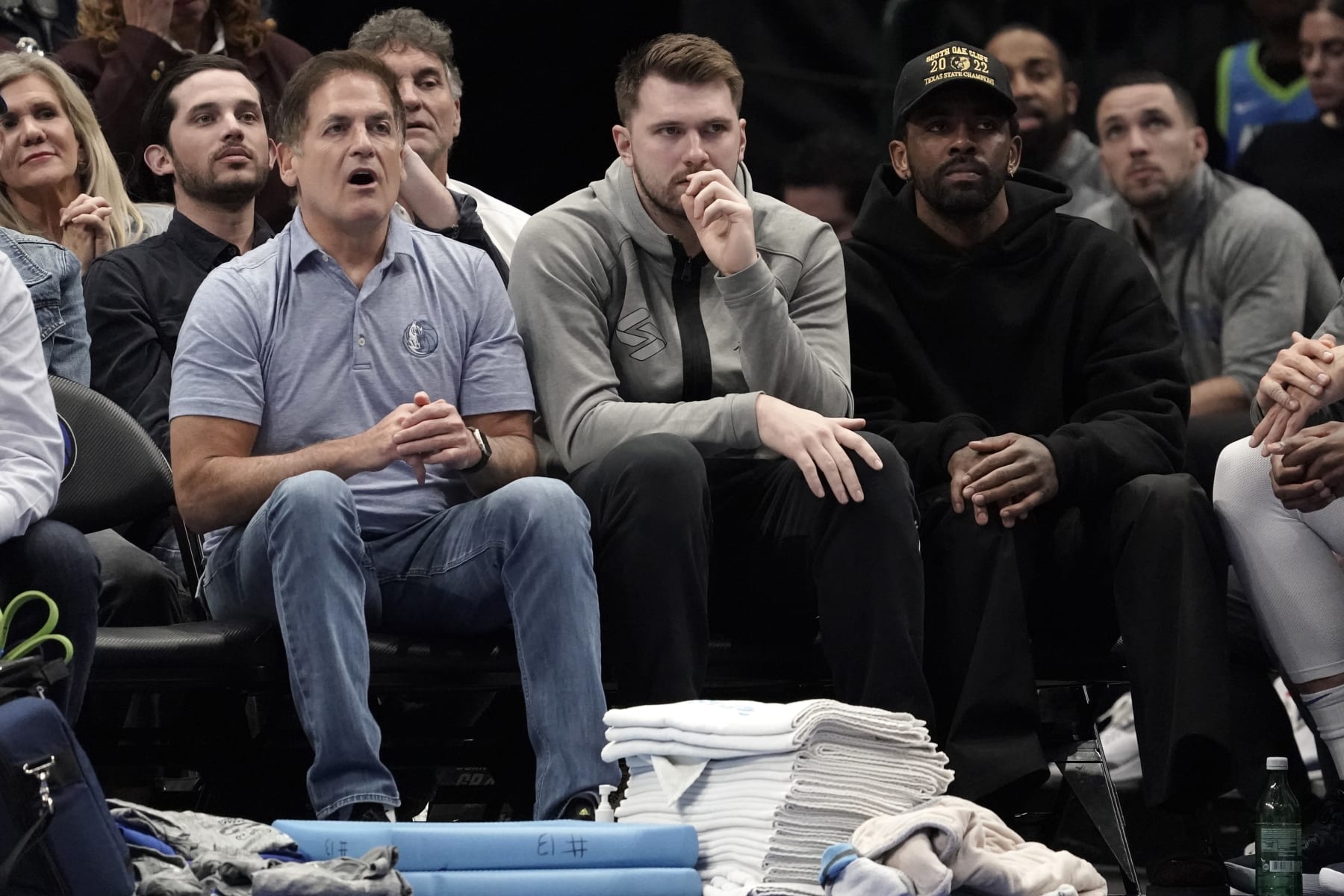 DALLAS, TEXAS - MARCH 13:  (L-R) Dallas Mavericks owner Mark Cuban, Luka Doncic and Kyrie Irving watch first-half play against the Memphis Grizzlies at American Airlines Center on March 13, 2023 in Dallas, Texas. NOTE TO USER: User expressly acknowledges and agrees that, by downloading and/or using this Photograph, user is consenting to the terms and conditions of the Getty Images License Agreement. (Photo by Sam Hodde/Getty Images)