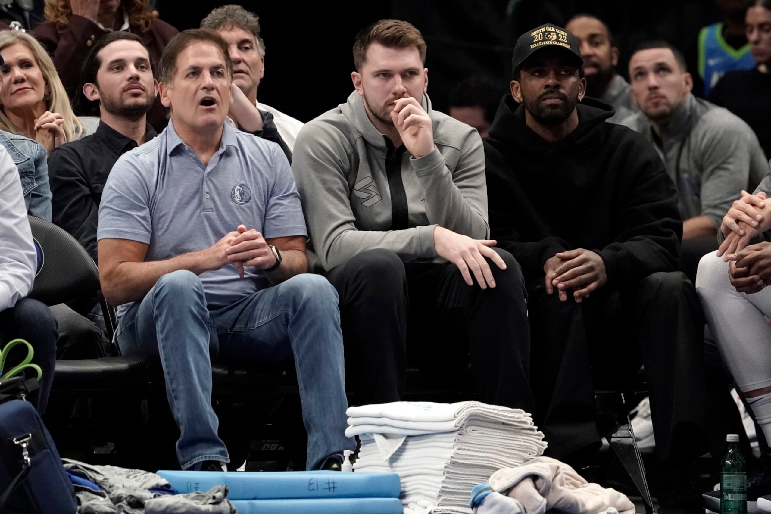 DALLAS, TEXAS - MARCH 13:  (L-R) Dallas Mavericks owner Mark Cuban, Luka Doncic and Kyrie Irving watch first-half play against the Memphis Grizzlies at American Airlines Center on March 13, 2023 in Dallas, Texas. NOTE TO USER: User expressly acknowledges and agrees that, by downloading and/or using this Photograph, user is consenting to the terms and conditions of the Getty Images License Agreement. (Photo by Sam Hodde/Getty Images)