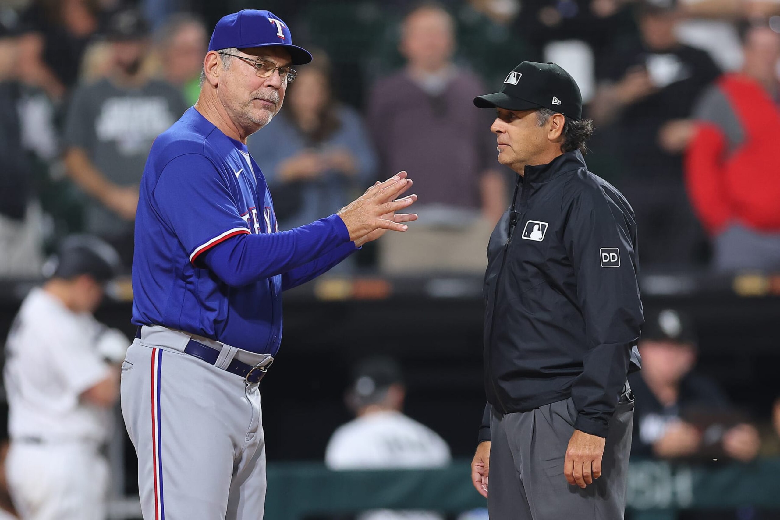 CHICAGO, ILLINOIS - JUNE 20: Manager Bruce Bochy #15 of the Texas Rangers argues with umpire James Hoye #92 after a run was overturned due to a blocking the plate violation by Jonah Heim #28 (not pictured) during the eighth inning at Guaranteed Rate Field on June 20, 2023 in Chicago, Illinois. (Photo by Michael Reaves/Getty Images)