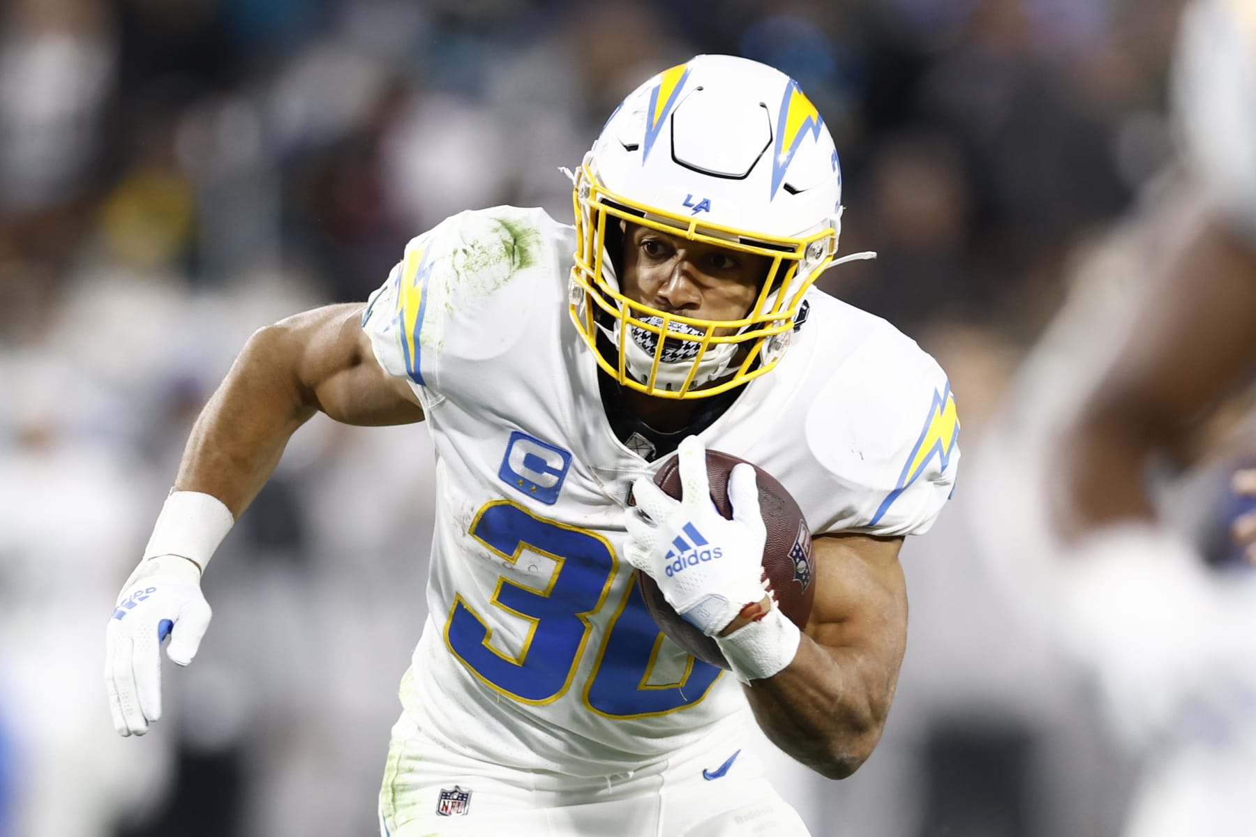 JACKSONVILLE, FLORIDA - JANUARY 14: Austin Ekeler #30 of the Los Angeles Chargers carries the ball against the Jacksonville Jaguars during the first half of the game in the AFC Wild Card playoff game at TIAA Bank Field on January 14, 2023 in Jacksonville, Florida. (Photo by Douglas P. DeFelice/Getty Images)