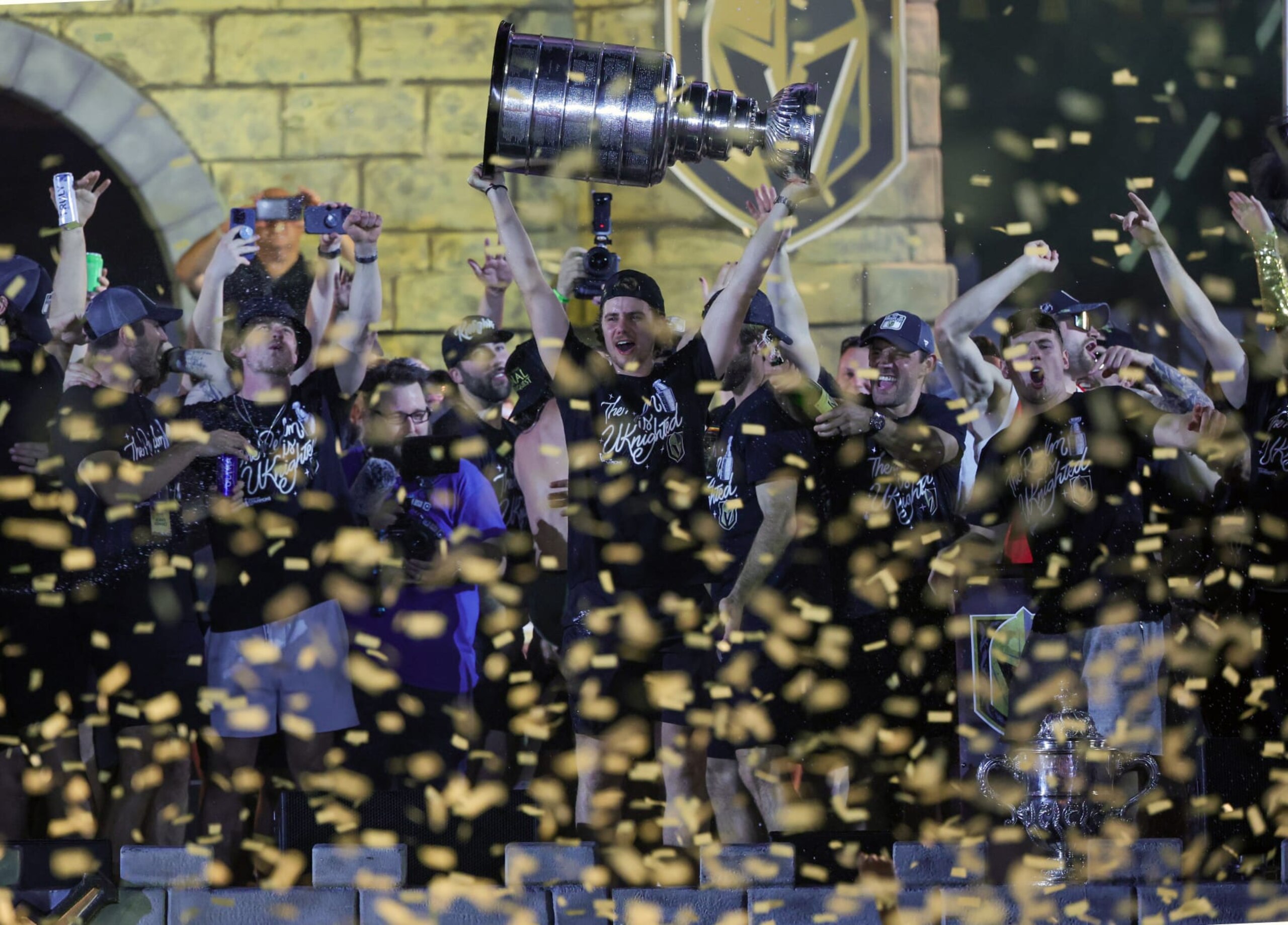 LAS VEGAS, NEVADA - JUNE 17: Brett Howden #21 of the Vegas Golden Knights hoists the Stanley Cup as he celebrates with teammates onstage during a victory parade and rally for the Golden Knights outside T-Mobile Arena on June 17, 2023 in Las Vegas, Nevada. The Golden Knights defeated the Florida Panthers four games to one to win the 2023 NHL Stanley Cup Final. (Photo by Ethan Miller/Getty Images)