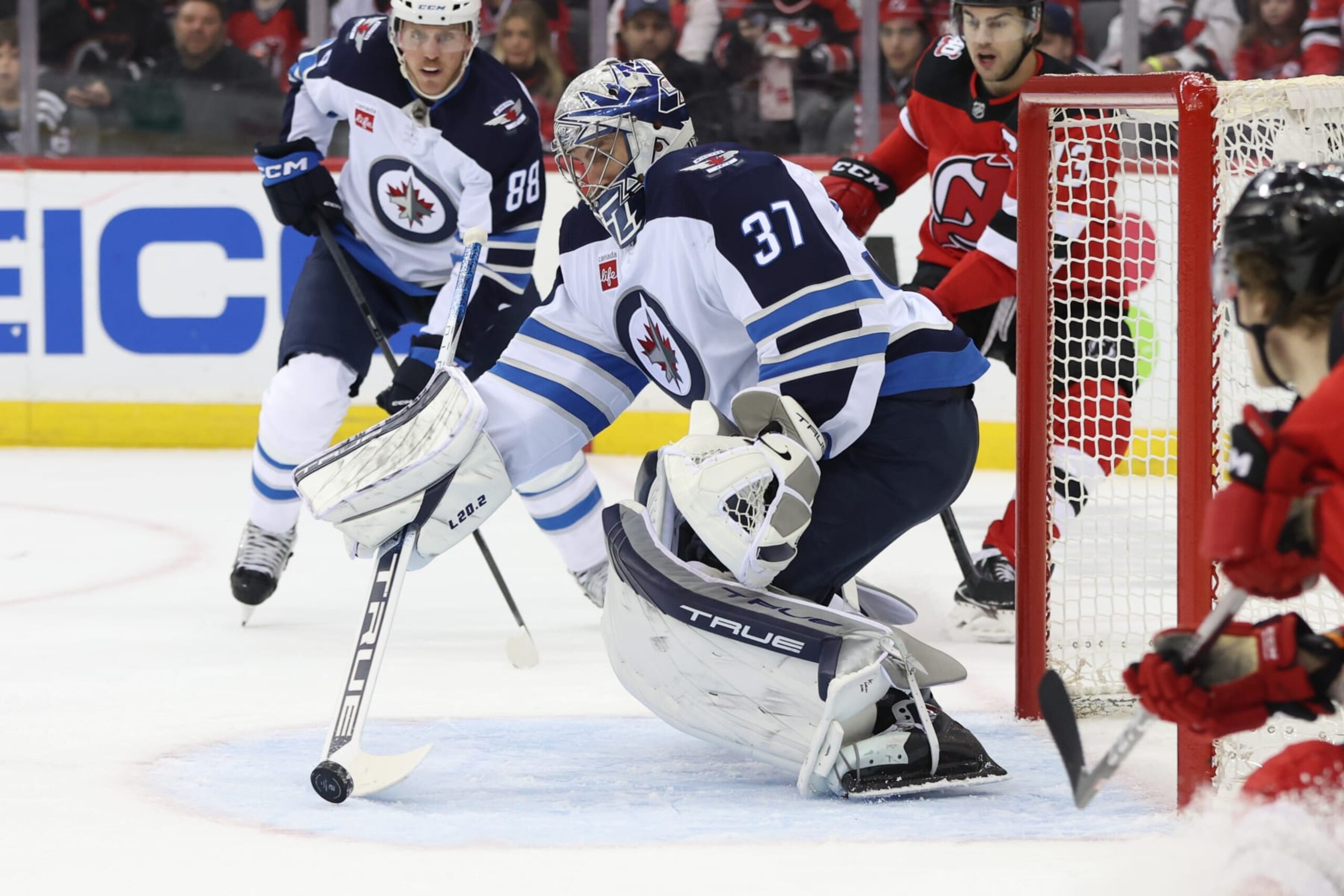 NEWARK, NJ - FEBRUARY 19: Winnipeg Jets goaltender Connor Hellebuyck (37) makes a save during the National Hockey League game between the Winnipeg Jets and the New Jersey Devils on February 19, 2023 at Prudential Center in Newark, NJ. (Photo by Andrew Mordzynski/Icon Sportswire via Getty Images)