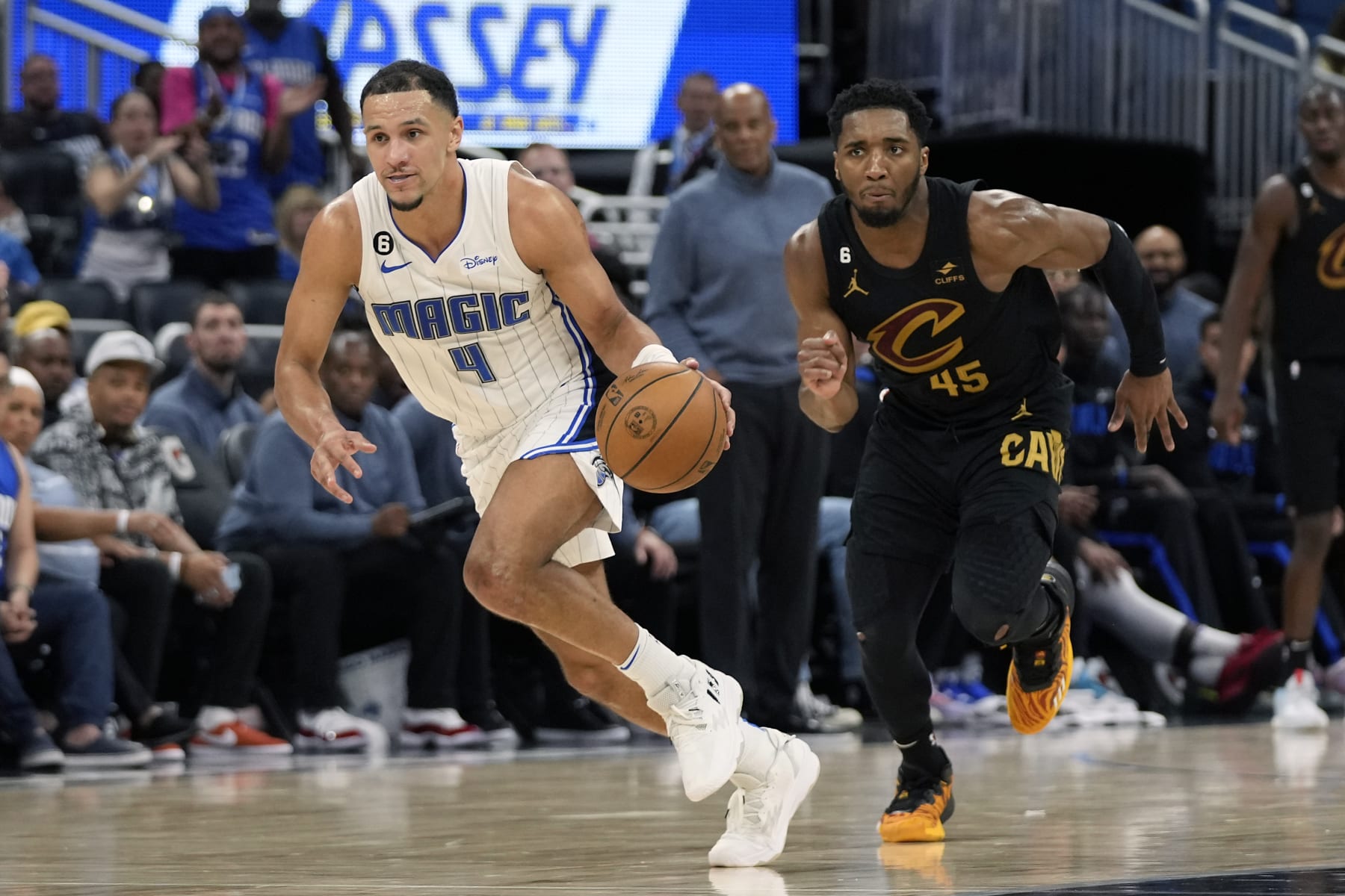 Orlando Magic's Jalen Suggs (4) takes off downcourt after stealing the ball from Cleveland Cavaliers' Donovan Mitchell (45) during the second half of an NBA basketball game, Tuesday, April 4, 2023, in Orlando, Fla. (AP Photo/John Raoux)