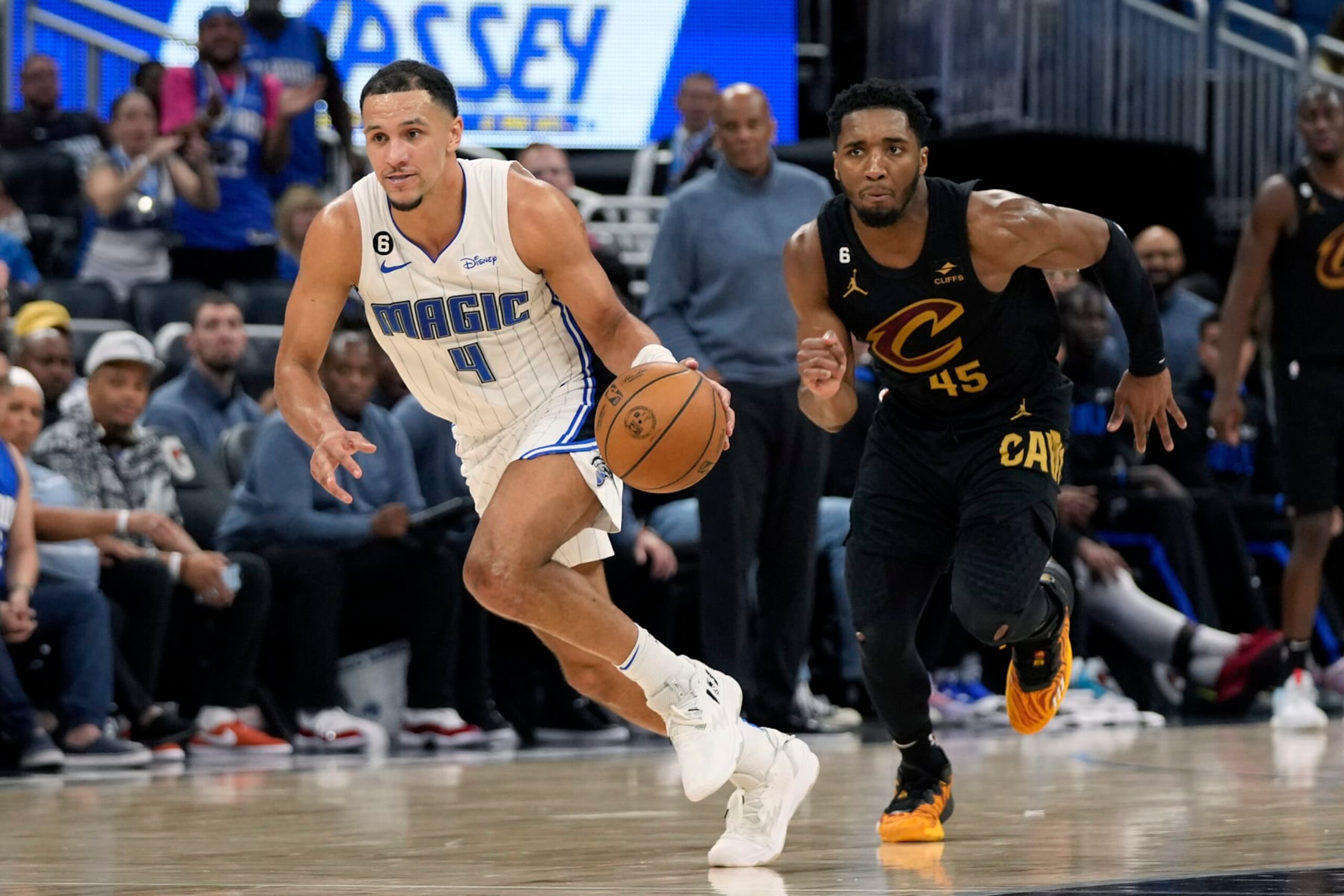 Orlando Magic's Jalen Suggs (4) takes off downcourt after stealing the ball from Cleveland Cavaliers' Donovan Mitchell (45) during the second half of an NBA basketball game, Tuesday, April 4, 2023, in Orlando, Fla. (AP Photo/John Raoux)