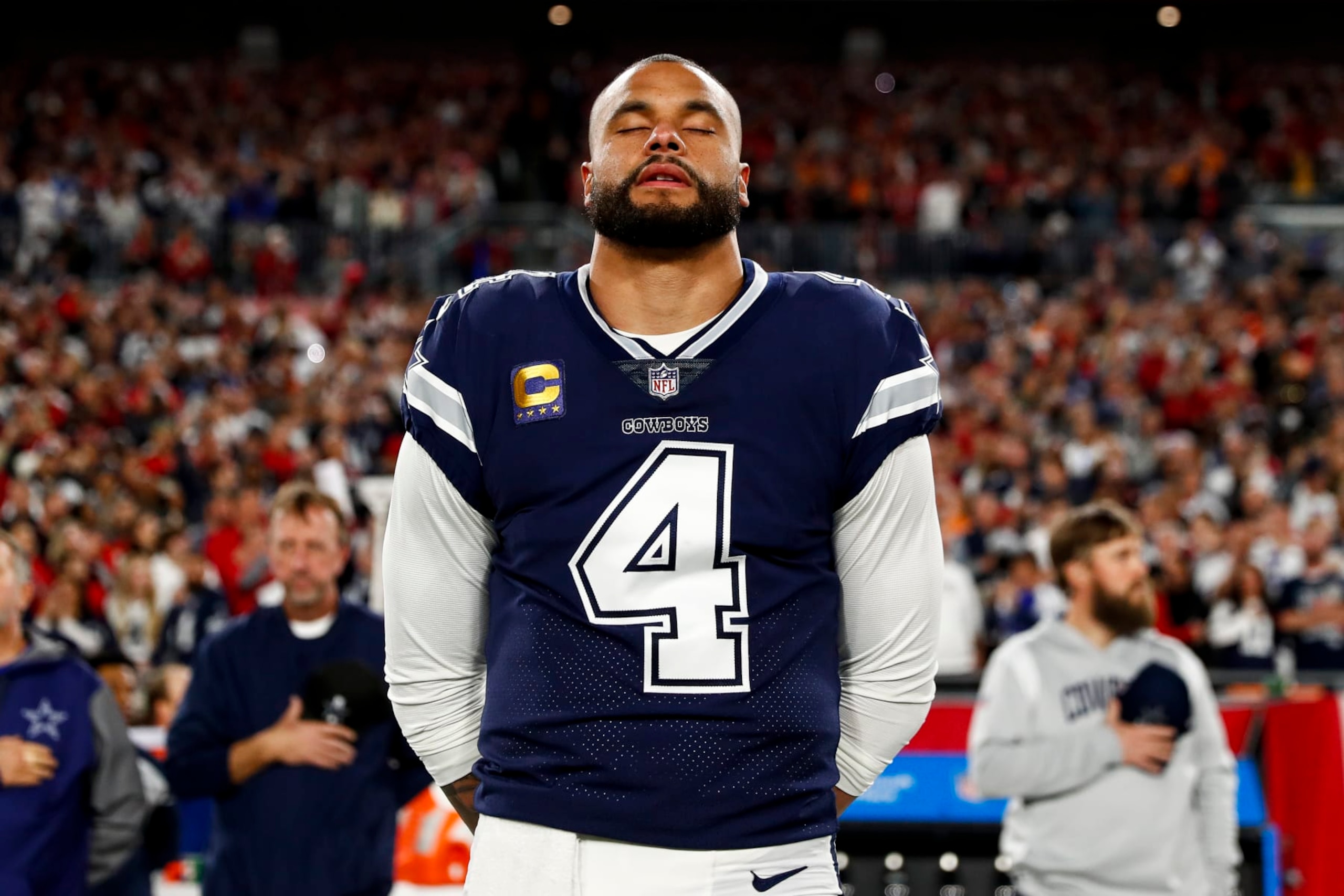 TAMPA, FL - JANUARY 16: Dak Prescott #4 of the Dallas Cowboys stands on the sidelines during the national anthem prior to an NFL wild card playoff football game against the Tampa Bay Buccaneers at Raymond James Stadium on January 16, 2023 in Tampa, Florida. (Photo by Kevin Sabitus/Getty Images)