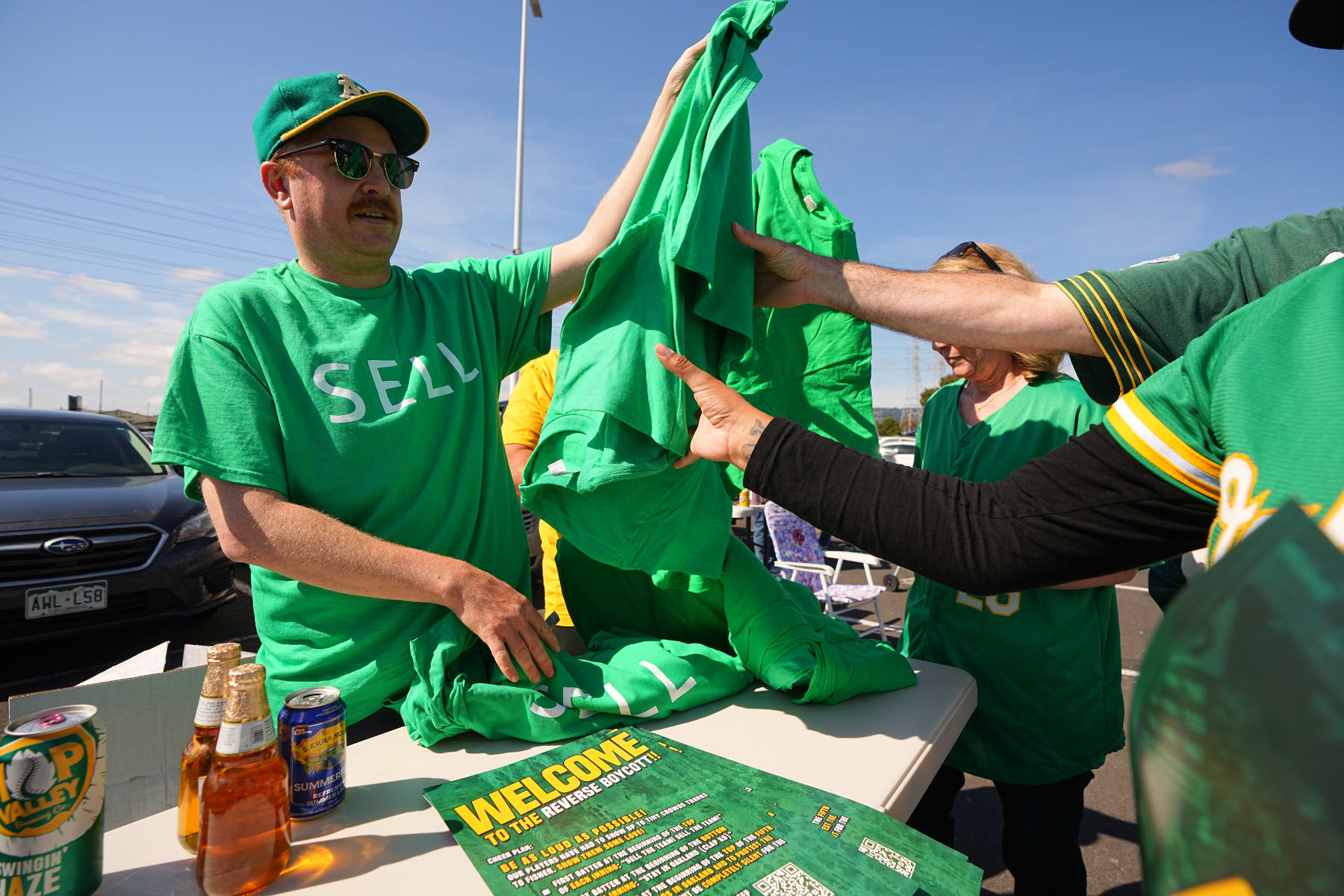 Baseball: Oakland Athletics fans distribute t shirts outside the stadium vs Tampa Bay Rays during a reverse boycott at the Oakland Coliseum. 
Oakland, CA 6/13/2023 
CREDIT: Erick W. Rasco (Photo by Erick W. Rasco/Sports Illustrated via Getty Images) 
(Set Number: X164373)