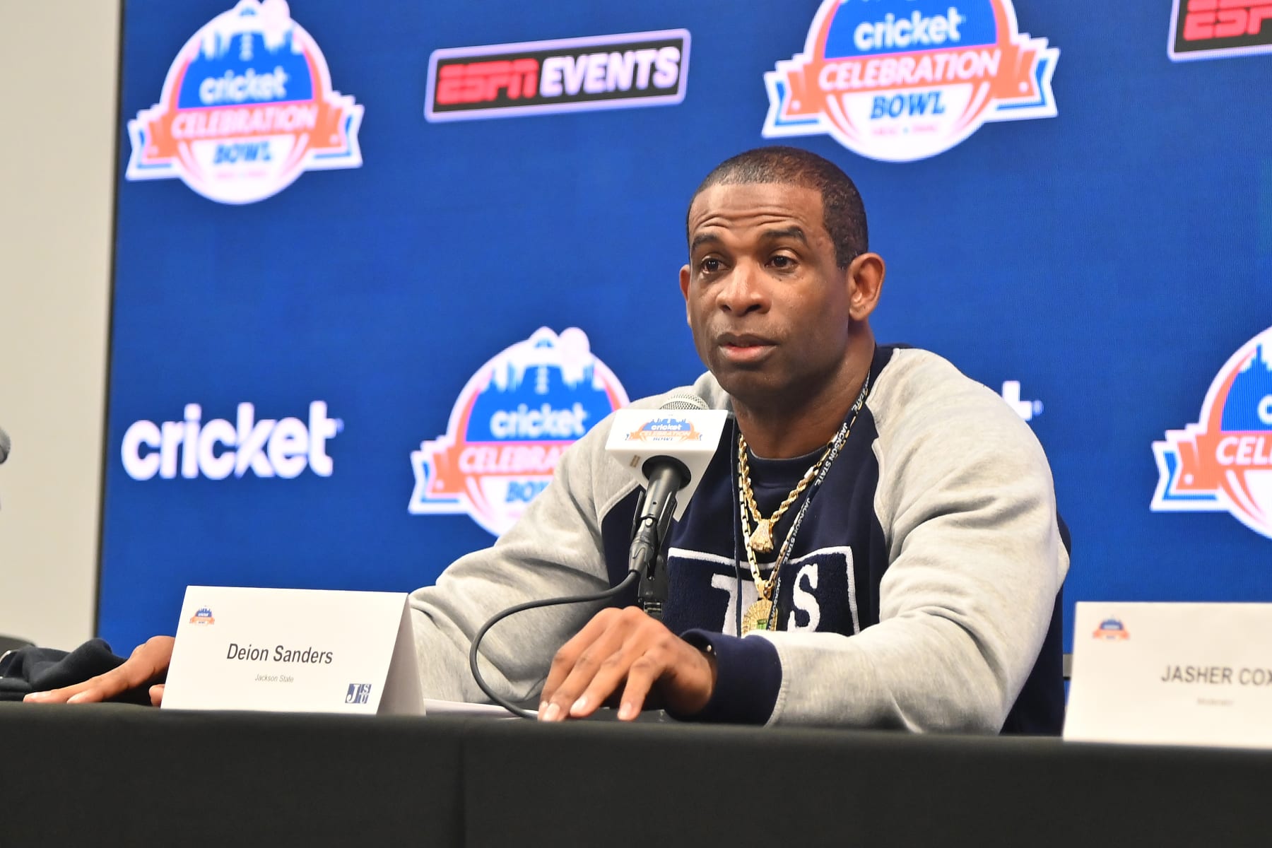ATLANTA, GEORGIA - DECEMBER 16: Head coach Deion Sanders of the Jackson State Tigers speaks with members of the press at the Jackson State University team press conference during Cricket Celebration Bowl Media Day at Mercedes-Benz Stadium on December 16, 2022 in Atlanta, Georgia. (Photo by Paras Griffin/Getty Images)