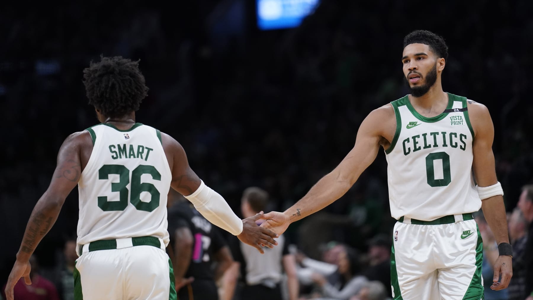Boston Celtics forward Jayson Tatum (0) slaps hands with Boston Celtics guard Marcus Smart (36) during an NBA basketball game, Wednesday, March 30, 2022, in Boston. (AP Photo/Charles Krupa)