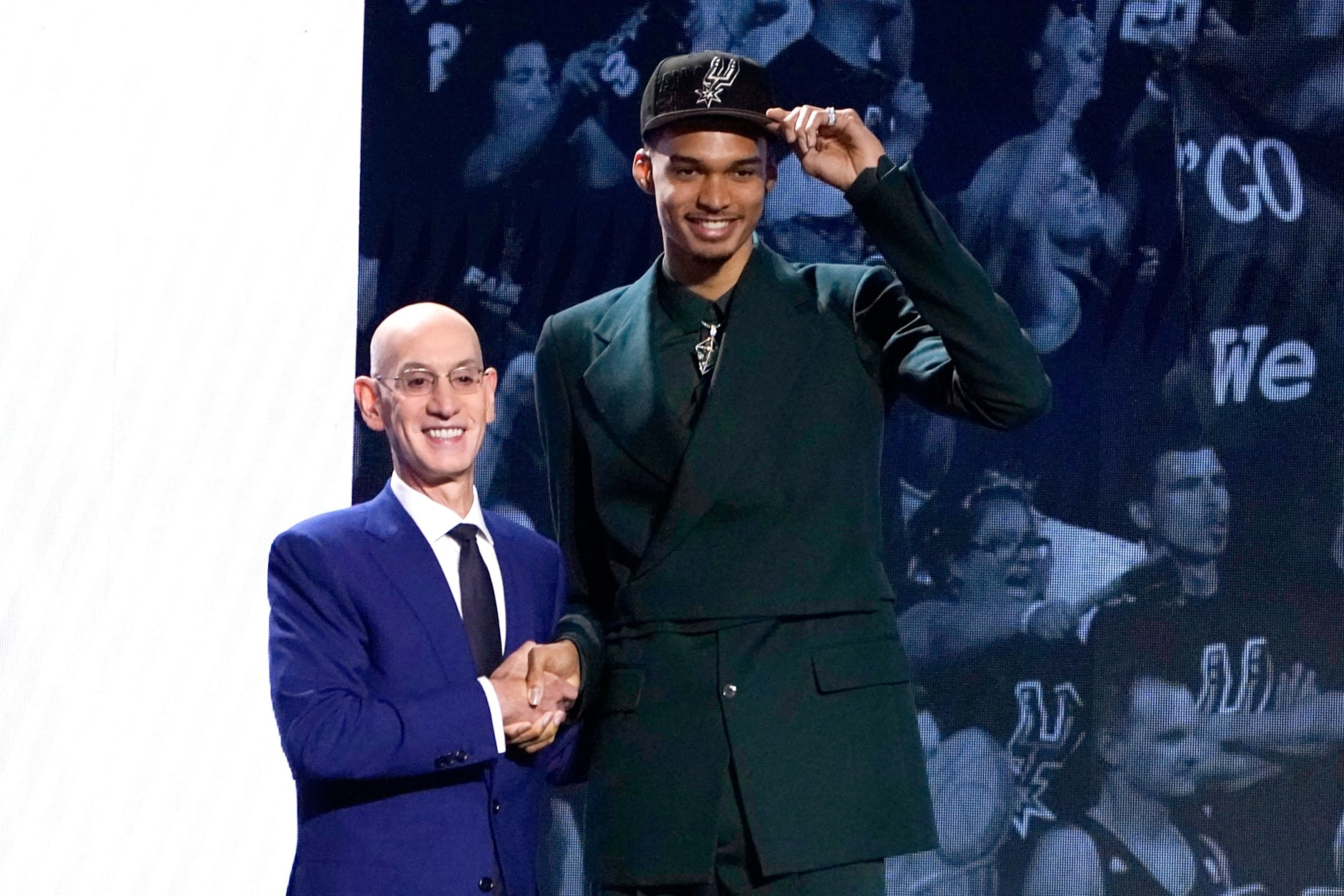 French basketball player Victor Wembanyama (R) shakes hands with NBA commissioner Adam Silver after being picked by the San Antonio Spurs during the NBA Draft at Barclays Center in New York city, on June 22, 2023. France's Victor Wembanyama was chosen with the top pick in the NBA Draft by the San Antonio Spurs on June 22, 2023, sparking wild celebrations as the Texas club reveled in landing the gifted teenager seen as a once-in-a-generation talent. (Photo by TIMOTHY A. CLARY / AFP) (Photo by TIMOTHY A. CLARY/AFP via Getty Images)