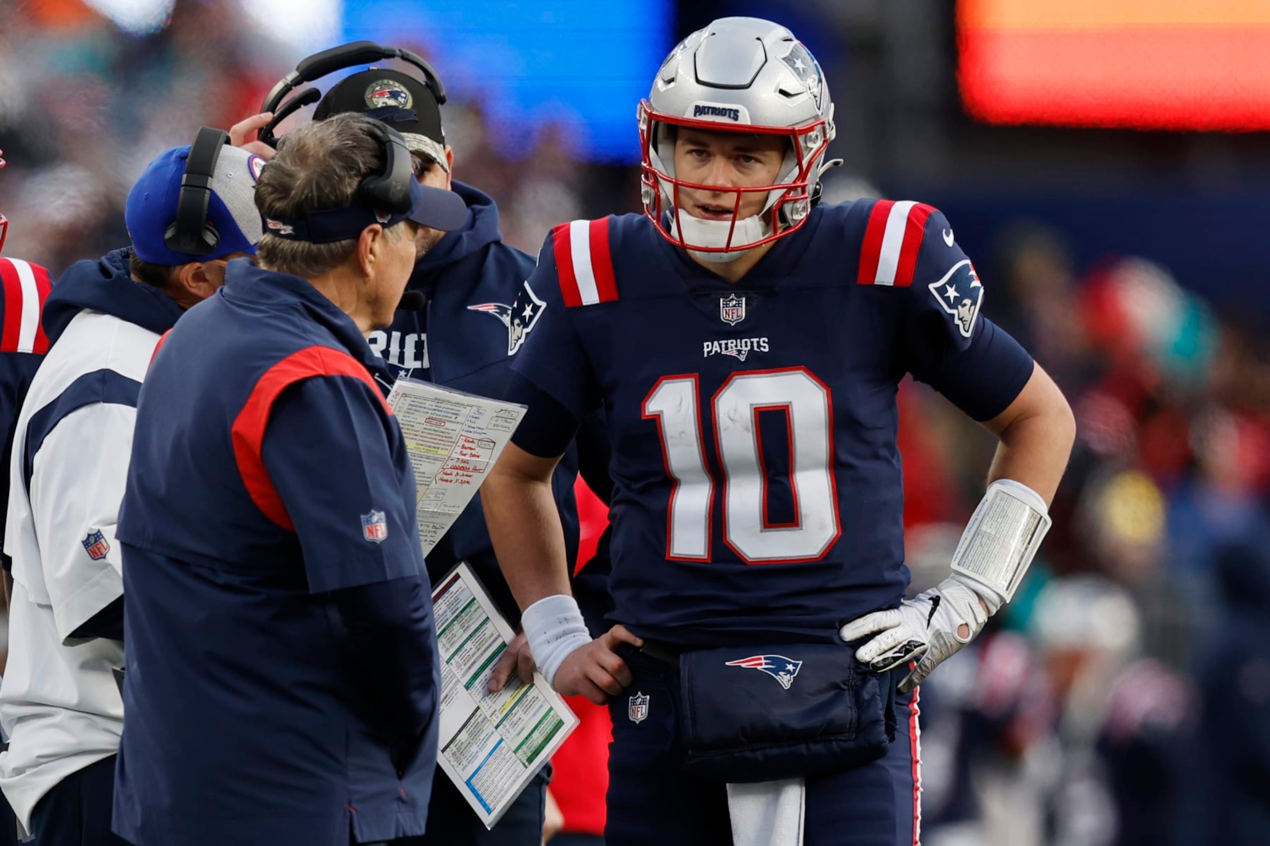 Patriots head coach Bill Belichick (left) and quarterback Mac Jones (right) Patriots head coach Bill Belichick (left) and quarterback Mac Jones (right)
