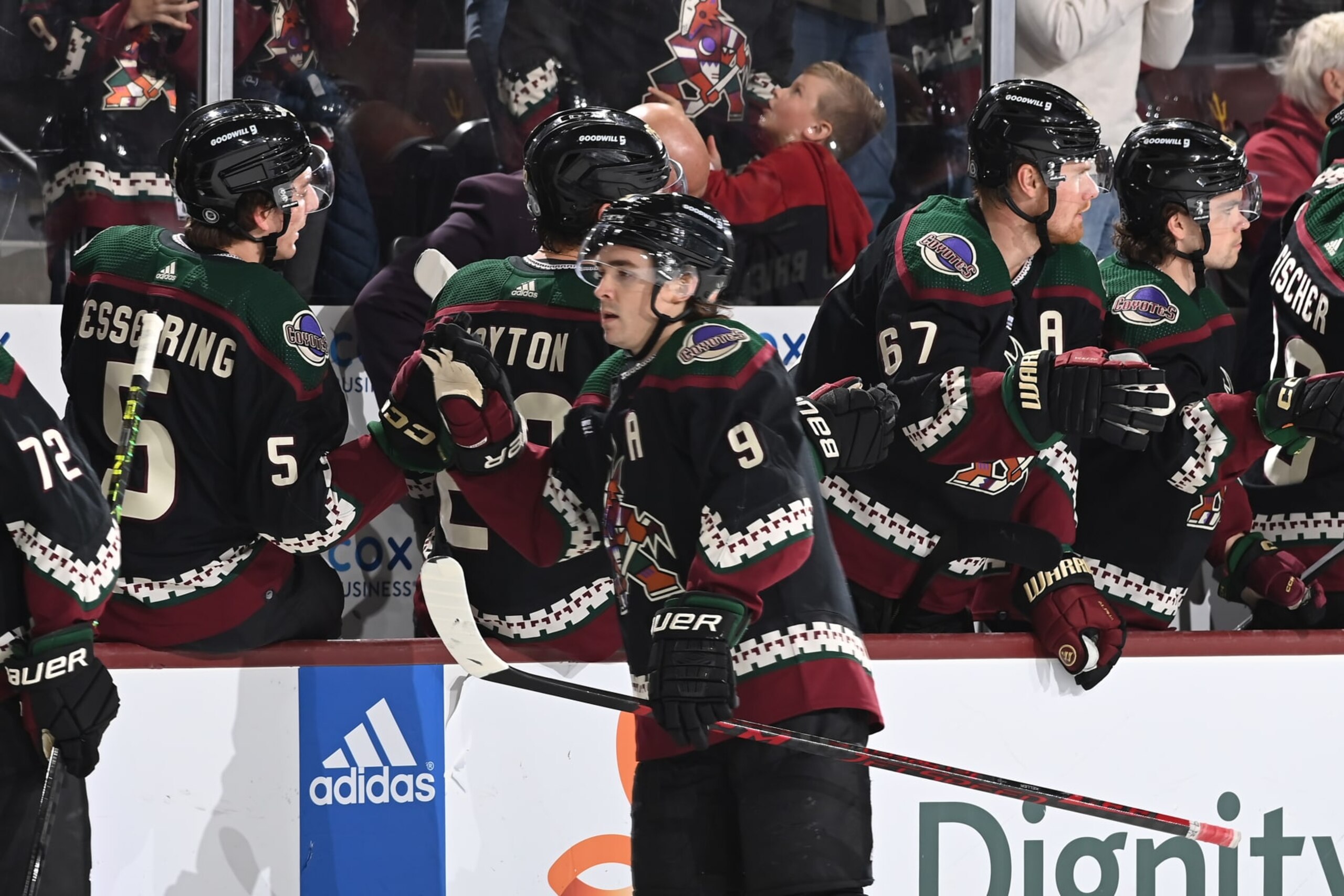 TEMPE, ARIZONA - APRIL 13: Clayton Keller #9 of the Arizona Coyotes celebrates with teammates on the bench after getting an assist on a goal by teammate Travis Boyd #72 against the Vancouver Canucks during the first period at Mullett Arena on April 13, 2023 in Tempe, Arizona. (Photo by Norm Hall/NHLI via Getty Images)