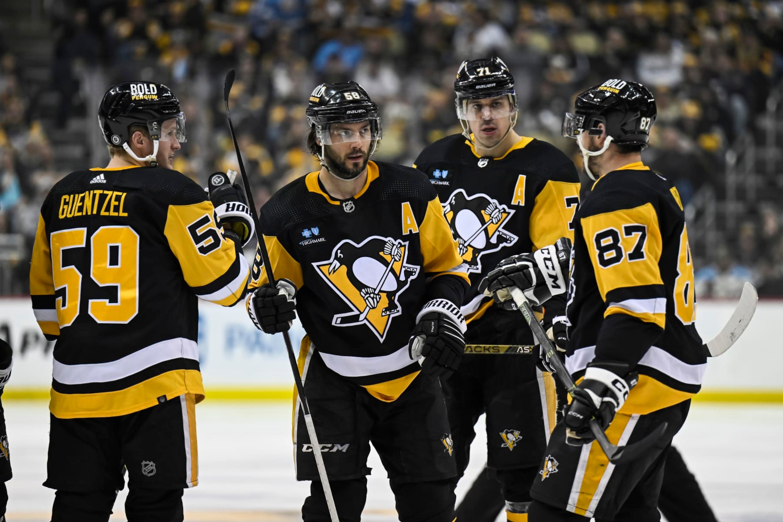 PITTSBURGH, PA - APRIL 11: Pittsburgh Penguins center Sidney Crosby (87), Pittsburgh Penguins Defenseman Kris Letang (58), Pittsburgh Penguins Center Evgeni Malkin (71), and Pittsburgh Penguins Left Wing Jake Guentzel (59) talk before a power play during the third period in the NHL game between the Pittsburgh Penguins and the Chicago Blackhawks on April 11, 2023, at PPG Paints Arena in Pittsburgh, PA. (Photo by Jeanine Leech/Icon Sportswire via Getty Images)
