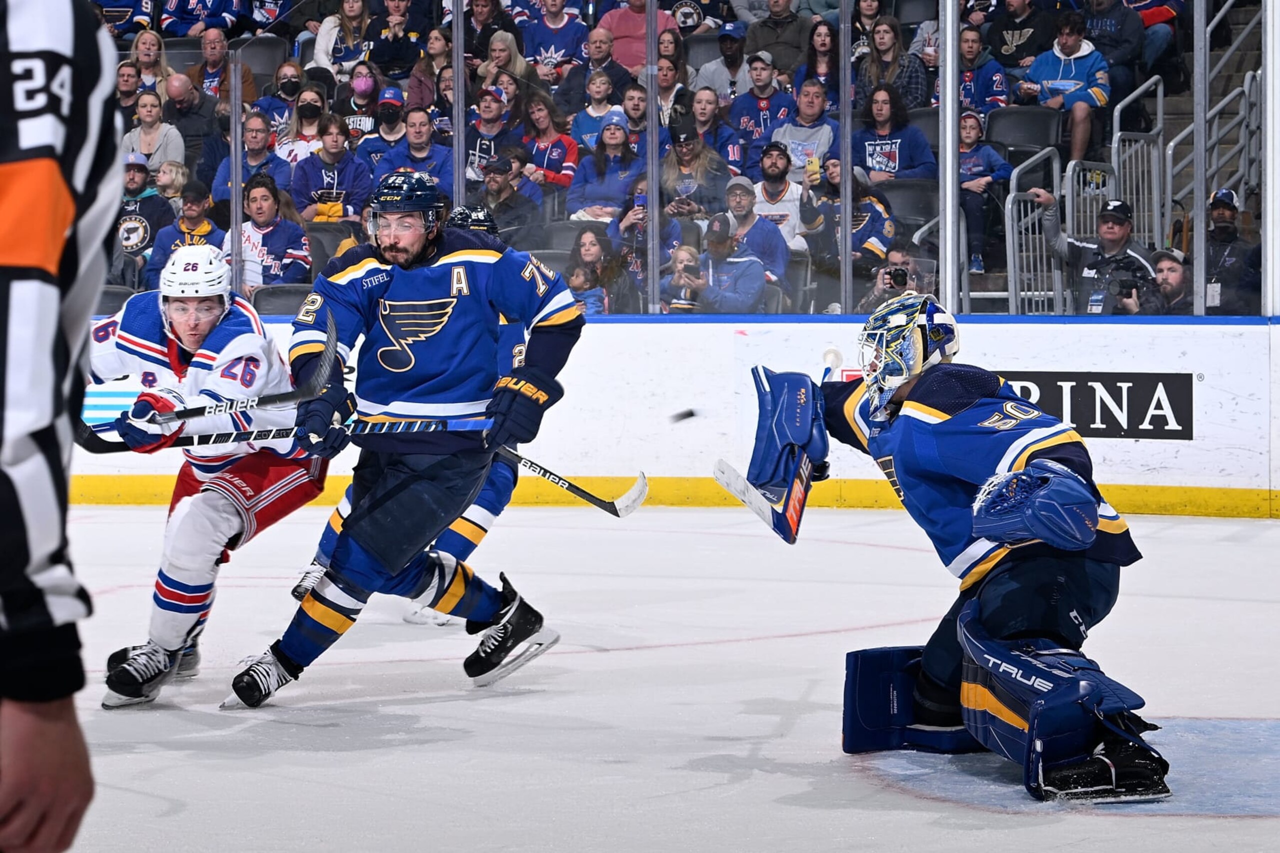 ST. LOUIS, MO - APRIL 6: Justin Faulk #72 and Jordan Binnington #50 of the St. Louis Blues defend the net against Jimmy Vesey #26 of the New York Rangers at the Enterprise Center on April 6, 2023 in St. Louis, Missouri. (Photo by Scott Rovak/NHLI via Getty Images)