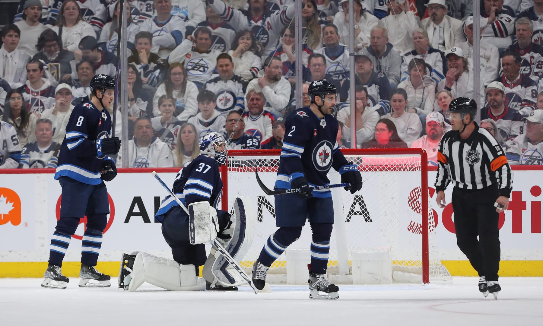 WINNIPEG, CANADA - APRIL 24: Saku Maenalanen #8, Connor Hellebuyck #37 and Dylan DeMelo #2 of the Winnipeg Jets react after conceding a goal during action against the Vegas Golden Knights in the second period of Game Four of the First Round of the 2023 Stanley Cup Playoffs on April 24, 2023 at Canada Life Centre in Winnipeg, Manitoba, Canada. (Photo by Jason Halstead/Getty Images)