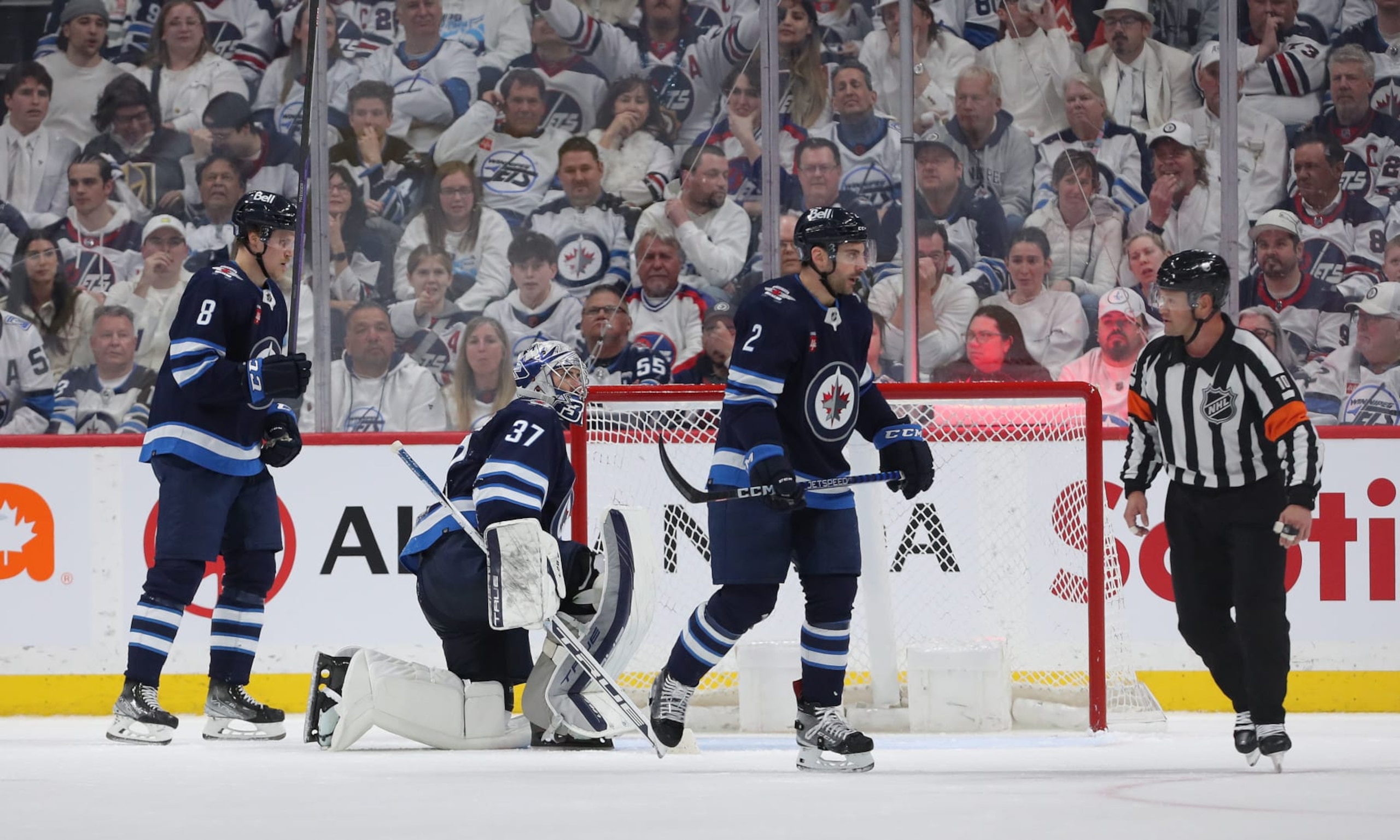WINNIPEG, CANADA - APRIL 24: Saku Maenalanen #8, Connor Hellebuyck #37 and Dylan DeMelo #2 of the Winnipeg Jets react after conceding a goal during action against the Vegas Golden Knights in the second period of Game Four of the First Round of the 2023 Stanley Cup Playoffs on April 24, 2023 at Canada Life Centre in Winnipeg, Manitoba, Canada. (Photo by Jason Halstead/Getty Images)