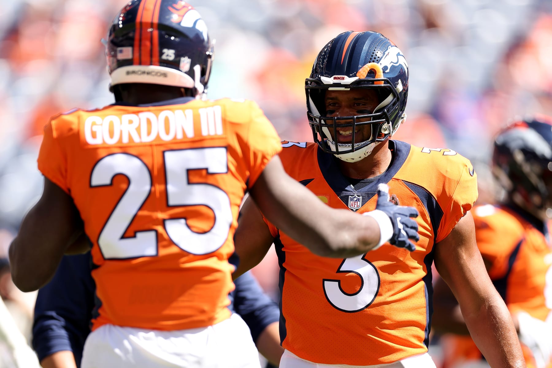 DENVER, COLORADO - SEPTEMBER 18: Melvin Gordon III #25 and Russell Wilson #3 of the Denver Broncos on field prior to playing the Houston Texans at Empower Field At Mile High on September 18, 2022 in Denver, Colorado. (Photo by Matthew Stockman/Getty Images)
