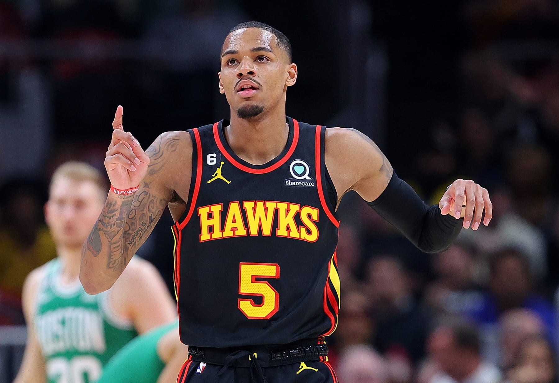 ATLANTA, GEORGIA - APRIL 23:  Dejounte Murray #5 of the Atlanta Hawks reacts after drawing a foul on a basket against the Boston Celtics during the first quarter of Game Four of the Eastern Conference First Round Playoffs at State Farm Arena on April 23, 2023 in Atlanta, Georgia. NOTE TO USER: User expressly acknowledges and agrees that, by downloading and or using this photograph, User is consenting to the terms and conditions of the Getty Images License Agreement.  (Photo by Kevin C. Cox/Getty Images)