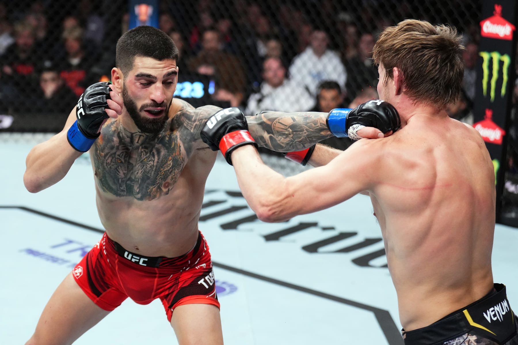 Ilia Topuria lands a jab against Bryce Mitchell.