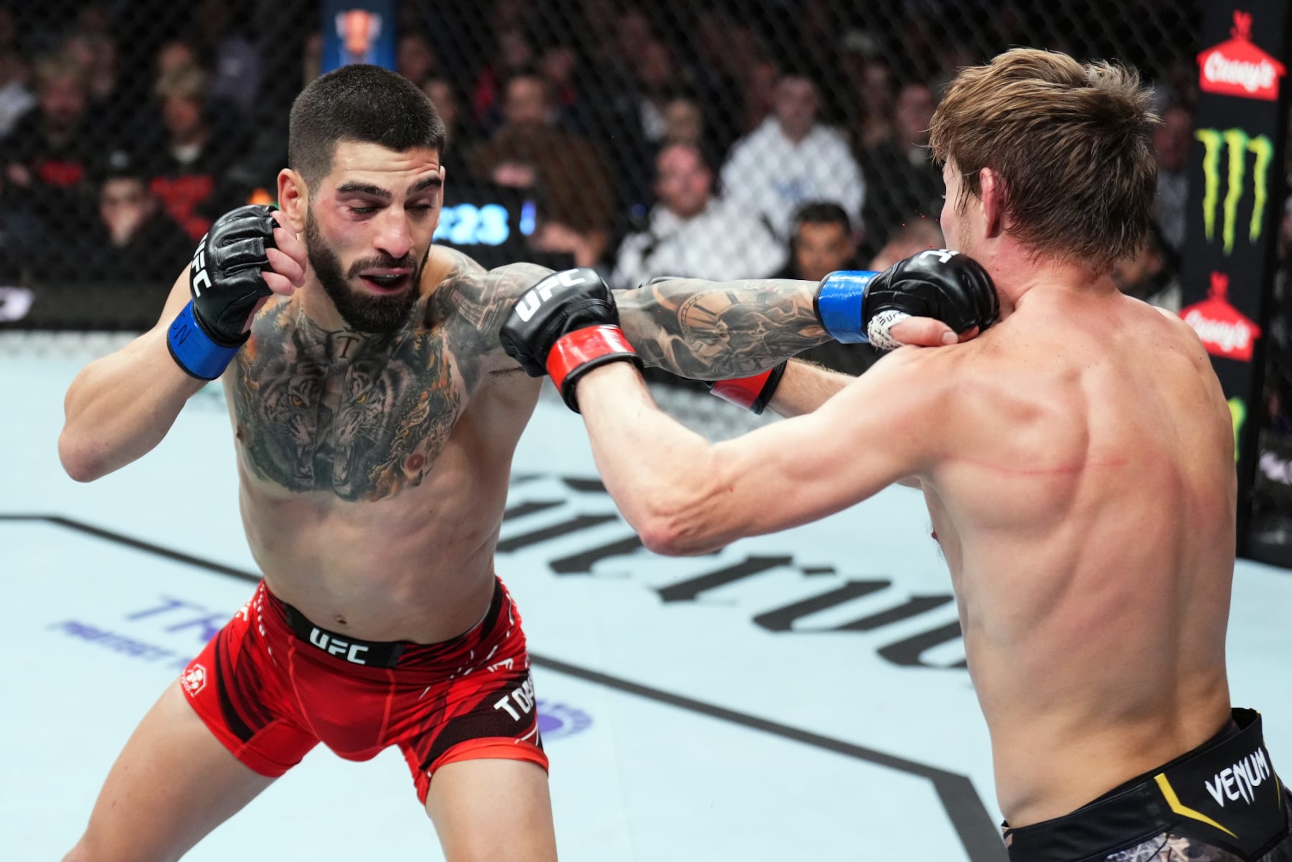 Ilia Topuria lands a jab against Bryce Mitchell.