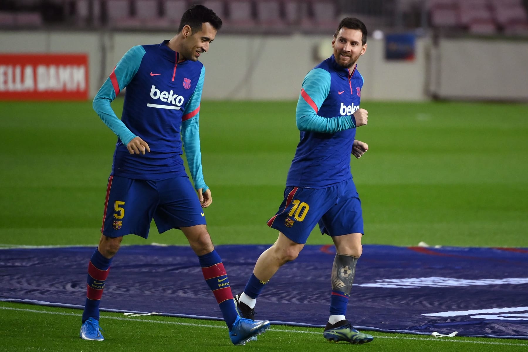 Barcelona's Argentinian forward Lionel Messi (R) and Barcelona's Spanish midfielder Sergio Busquets warm up before the Spanish League football match between FC Barcelona and Deportivo Alaves at the Camp Nou stadium in Barcelona on February 13, 2021. (Photo by LLUIS GENE / AFP) (Photo by LLUIS GENE/AFP via Getty Images)
