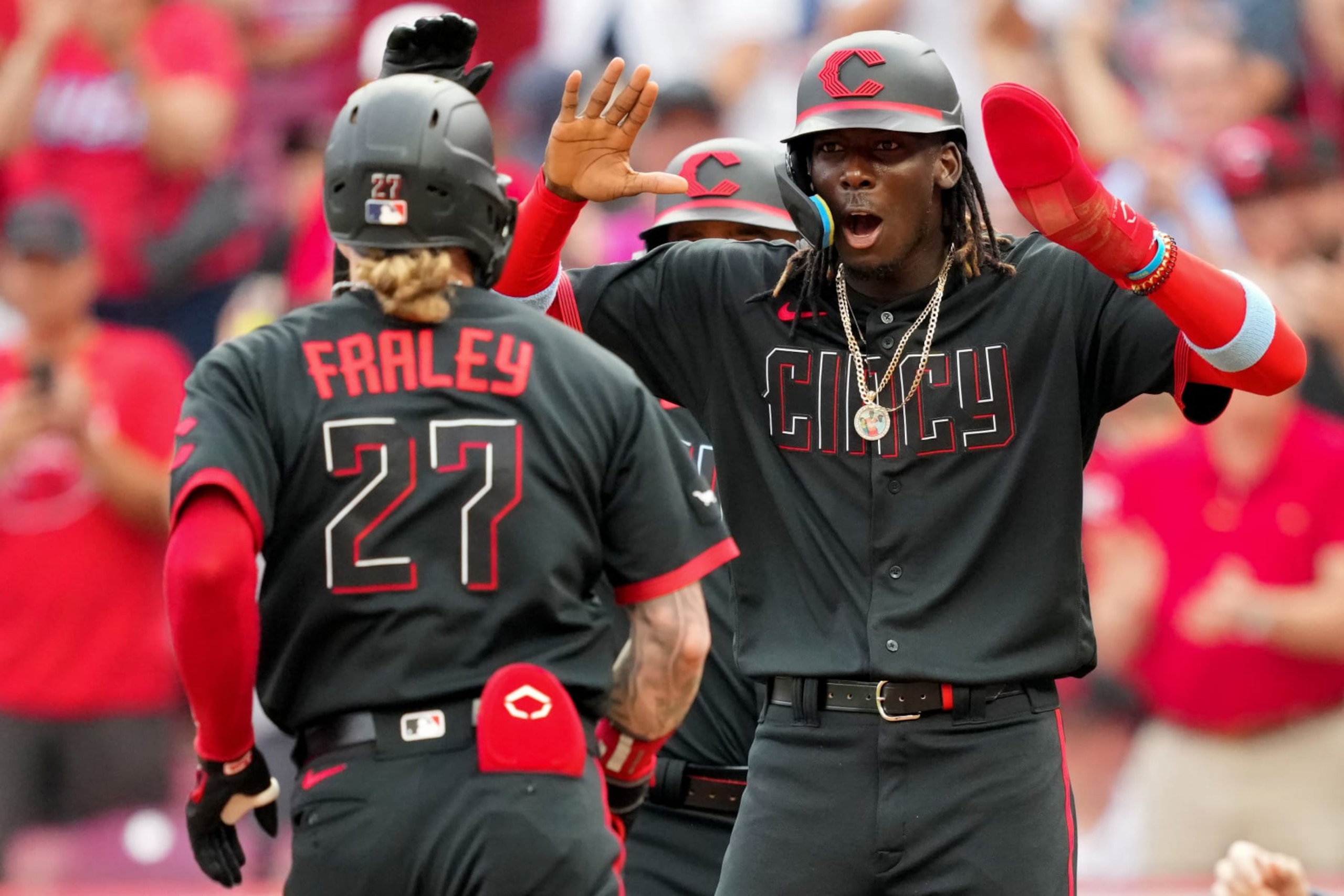 CINCINNATI, OHIO - JUNE 23: Jake Fraley #27 and Elly De La Cruz #44 of the Cincinnati Reds celebrate after Fraley hit a home run in the second inning against the Atlanta Braves at Great American Ball Park on June 23, 2023 in Cincinnati, Ohio. (Photo by Dylan Buell/Getty Images)