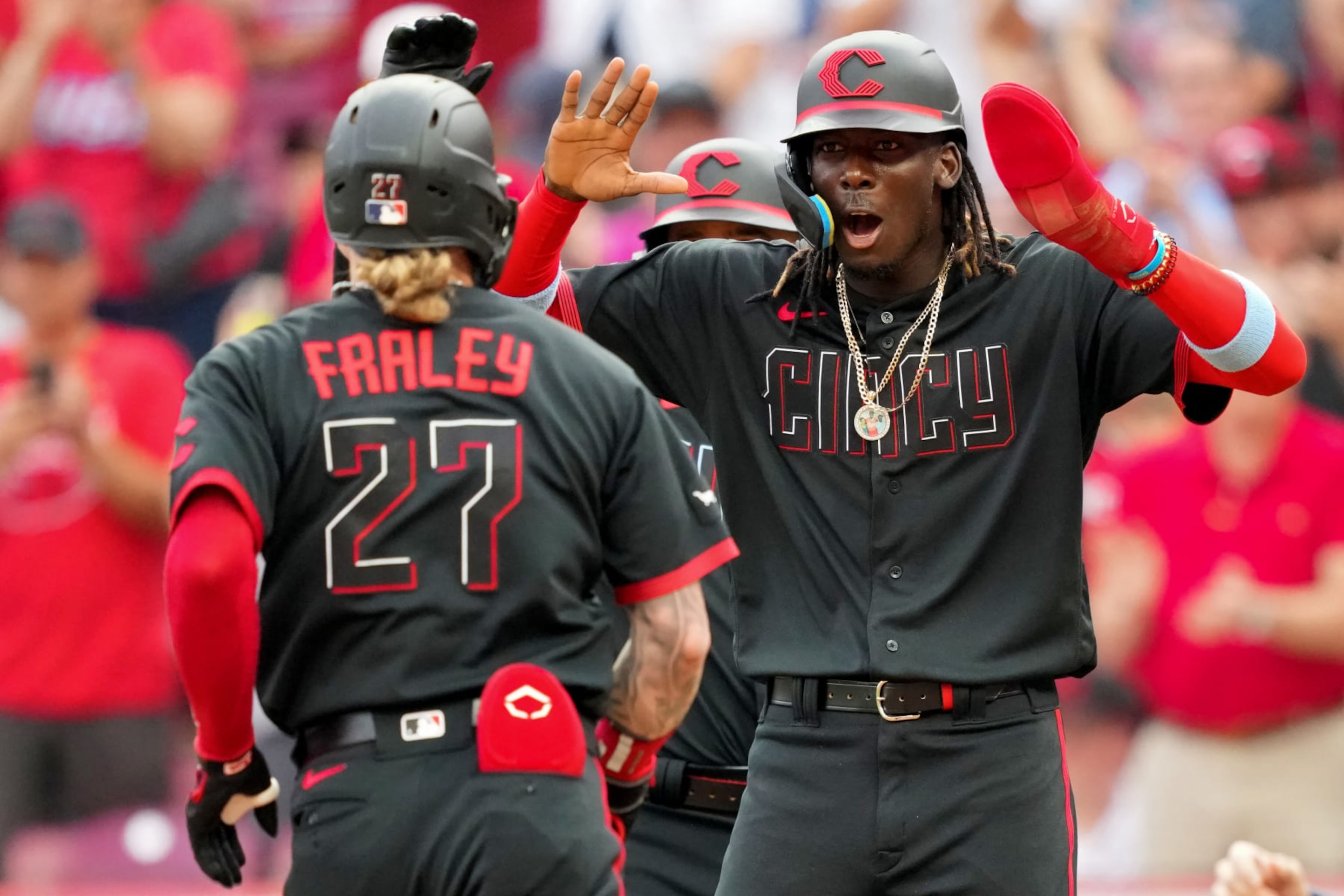 CINCINNATI, OHIO - JUNE 23: Jake Fraley #27 and Elly De La Cruz #44 of the Cincinnati Reds celebrate after Fraley hit a home run in the second inning against the Atlanta Braves at Great American Ball Park on June 23, 2023 in Cincinnati, Ohio. (Photo by Dylan Buell/Getty Images)