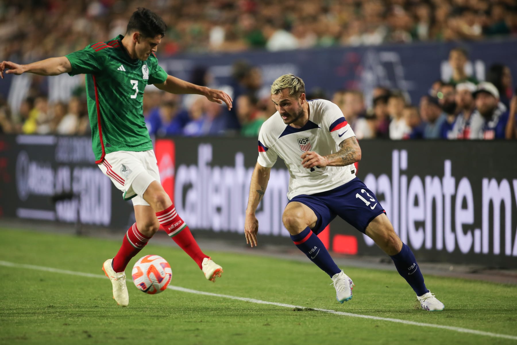 GLENDALE, AZ - APRIL 19: Jordan Morris #13 of the United States controls the ball in front of Israel Reyes #3 of Mexico during an international friendly game between Mexico and USMNT at State Farm Stadium on April 19, 2023 in Glendale, Arizona. (Photo by Mike Janosz/USSF/Getty Images).