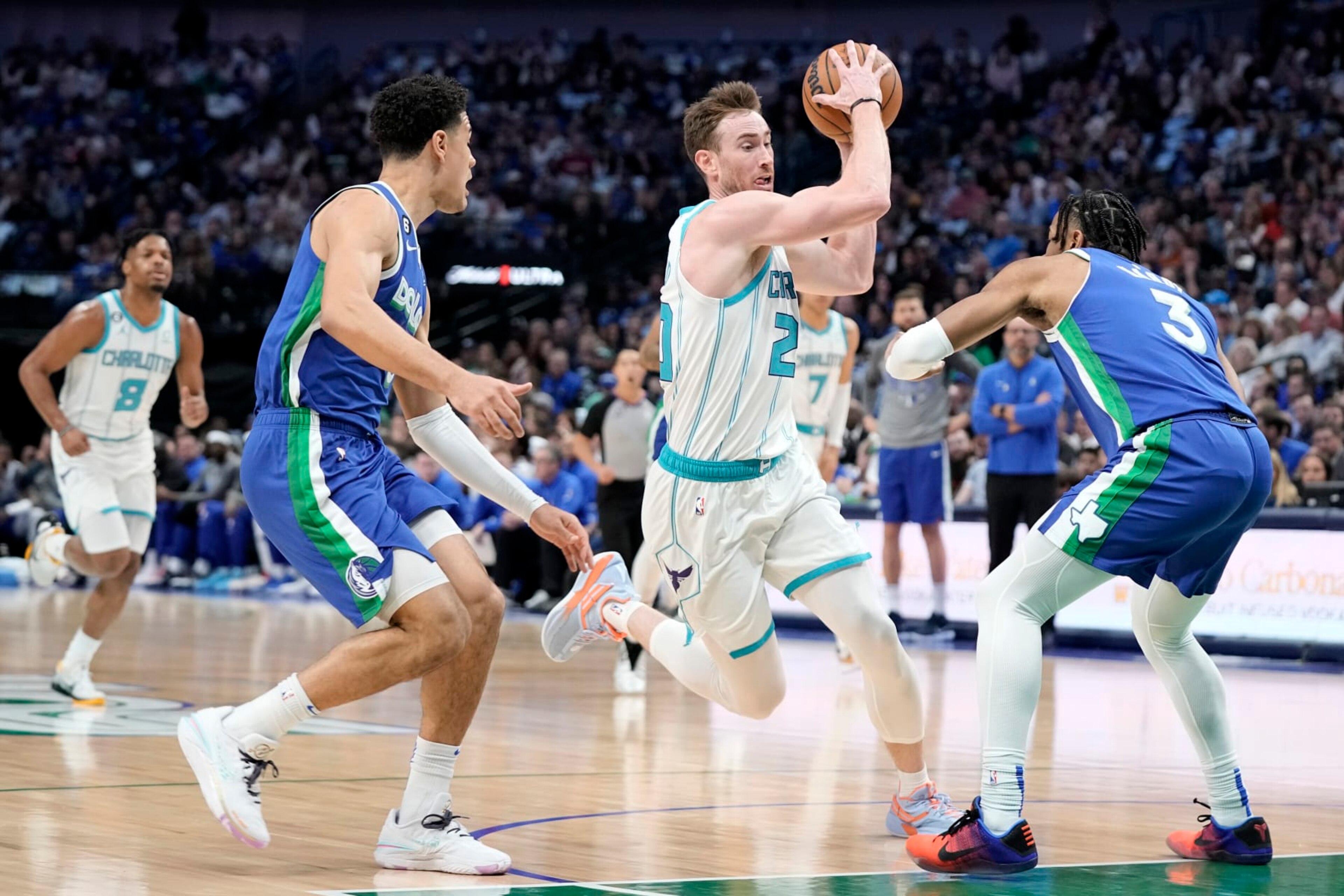 DALLAS, TEXAS - MARCH 24: Gordon Hayward #20 of the Charlotte Hornets makes a move to the basket between Josh Green #8 and Jaden Hardy #3 of the Dallas Mavericks during the first half at American Airlines Center on March 24, 2023 in Dallas, Texas. NOTE TO USER: User expressly acknowledges and agrees that, by downloading and/or using this Photograph, user is consenting to the terms and conditions of the Getty Images License Agreement. (Photo by Sam Hodde/Getty Images) DALLAS, TEXAS - MARCH 24: Gordon Hayward #20 of the Charlotte Hornets makes a move to the basket between Josh Green #8 and Jaden Hardy #3 of the Dallas Mavericks during the first half at American Airlines Center on March 24, 2023 in Dallas, Texas. NOTE TO USER: User expressly acknowledges and agrees that, by downloading and/or using this Photograph, user is consenting to the terms and conditions of the Getty Images License Agreement. (Photo by Sam Hodde/Getty Images)