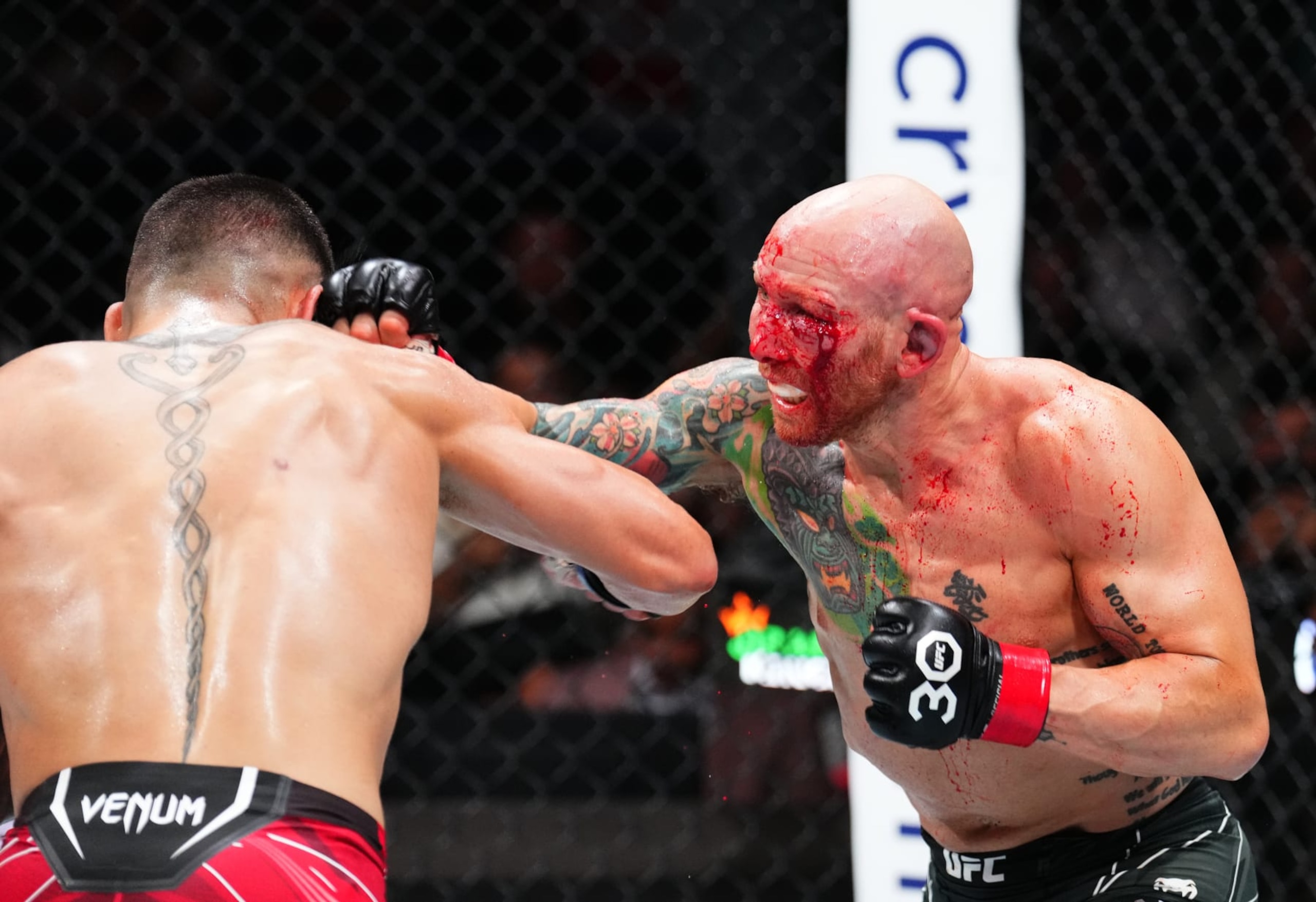 JACKSONVILLE, FLORIDA - JUNE 24:  (R-L) Josh Emmett punches Ilia Topuria of Germanyin their featherweight fight during the UFC Fight Night event at Vystar Veterans Memorial Arena on June 24, 2023 in Jacksonville, Florida. (Photo by Josh Hedges/Zuffa LLC)