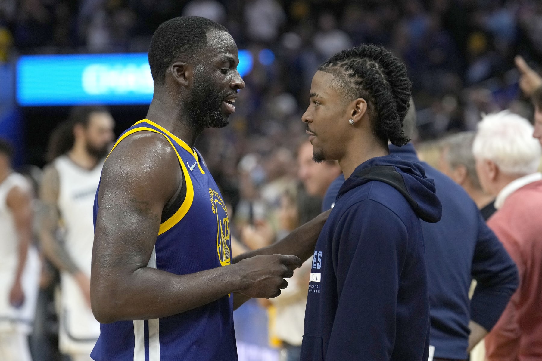 Golden State Warriors forward Draymond Green, left, talks with Memphis Grizzlies' Ja Morant after Game 6 of an NBA basketball Western Conference playoff semifinal in San Francisco, Friday, May 13, 2022. The Warriors won 110-96 and advanced to the conference finals. (AP Photo/Tony Avelar)