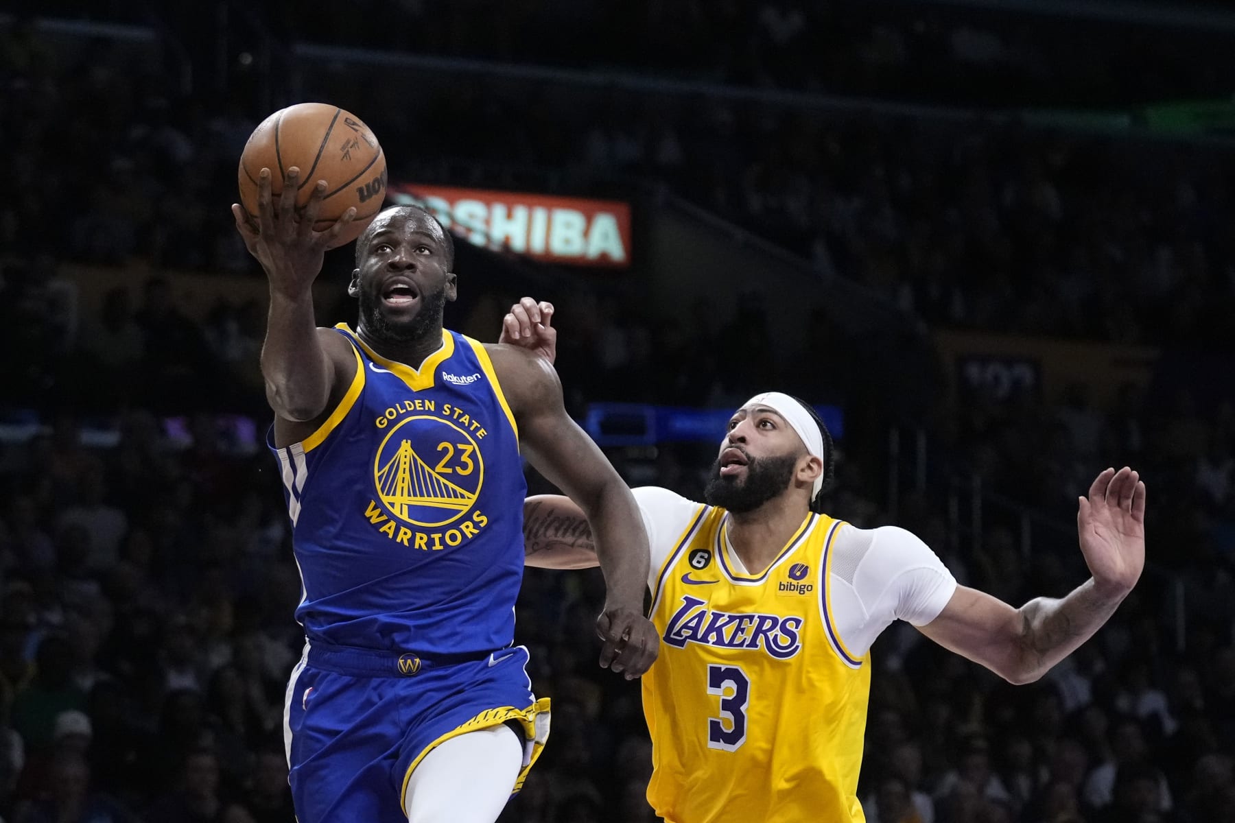 Golden State Warriors forward Draymond Green, left, shoots as Los Angeles Lakers forward Anthony Davis defends during the first half in Game 4 of an NBA basketball Western Conference semifinal Monday, May 8, 2023, in Los Angeles. (AP Photo/Marcio Jose Sanchez)