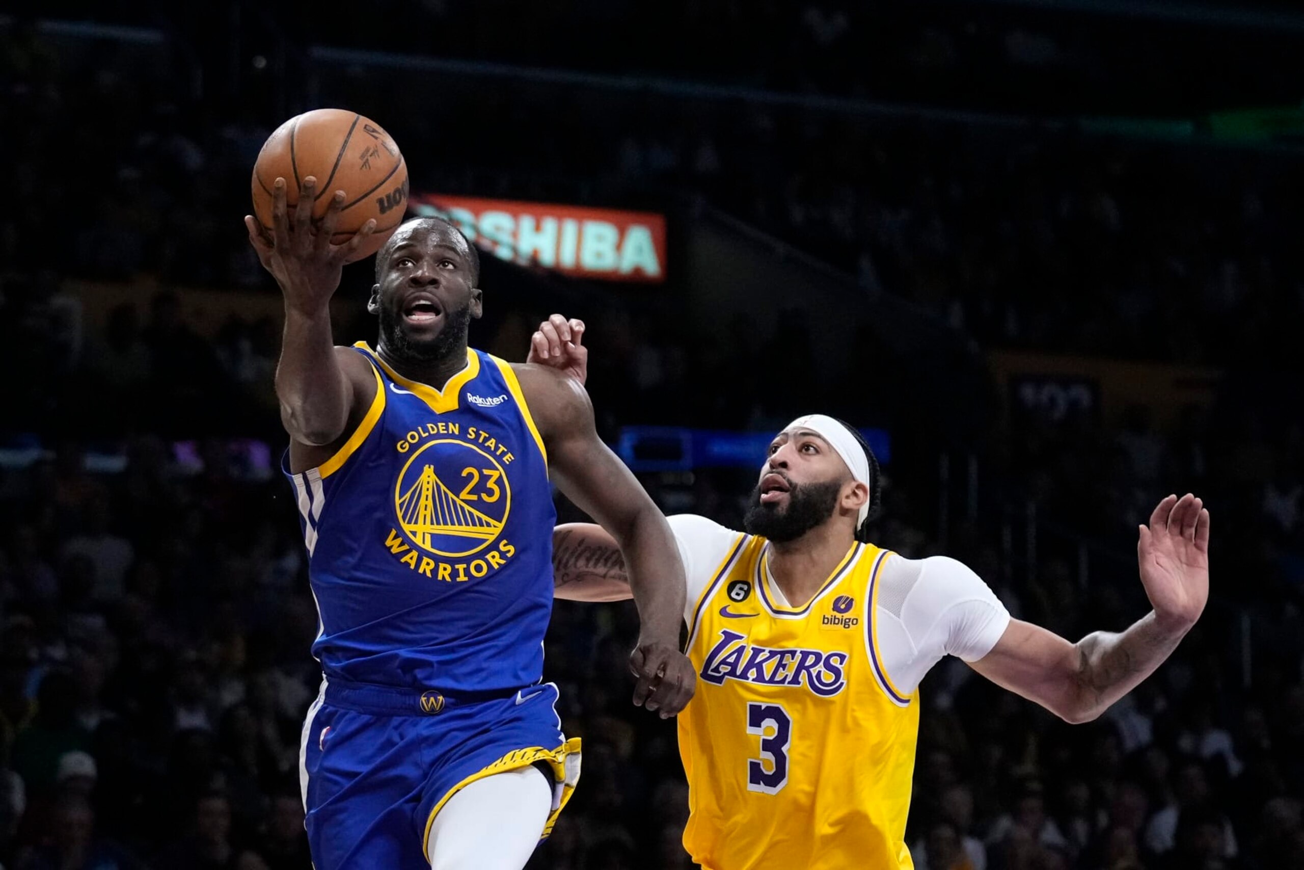 Golden State Warriors forward Draymond Green, left, shoots as Los Angeles Lakers forward Anthony Davis defends during the first half in Game 4 of an NBA basketball Western Conference semifinal Monday, May 8, 2023, in Los Angeles. (AP Photo/Marcio Jose Sanchez)
