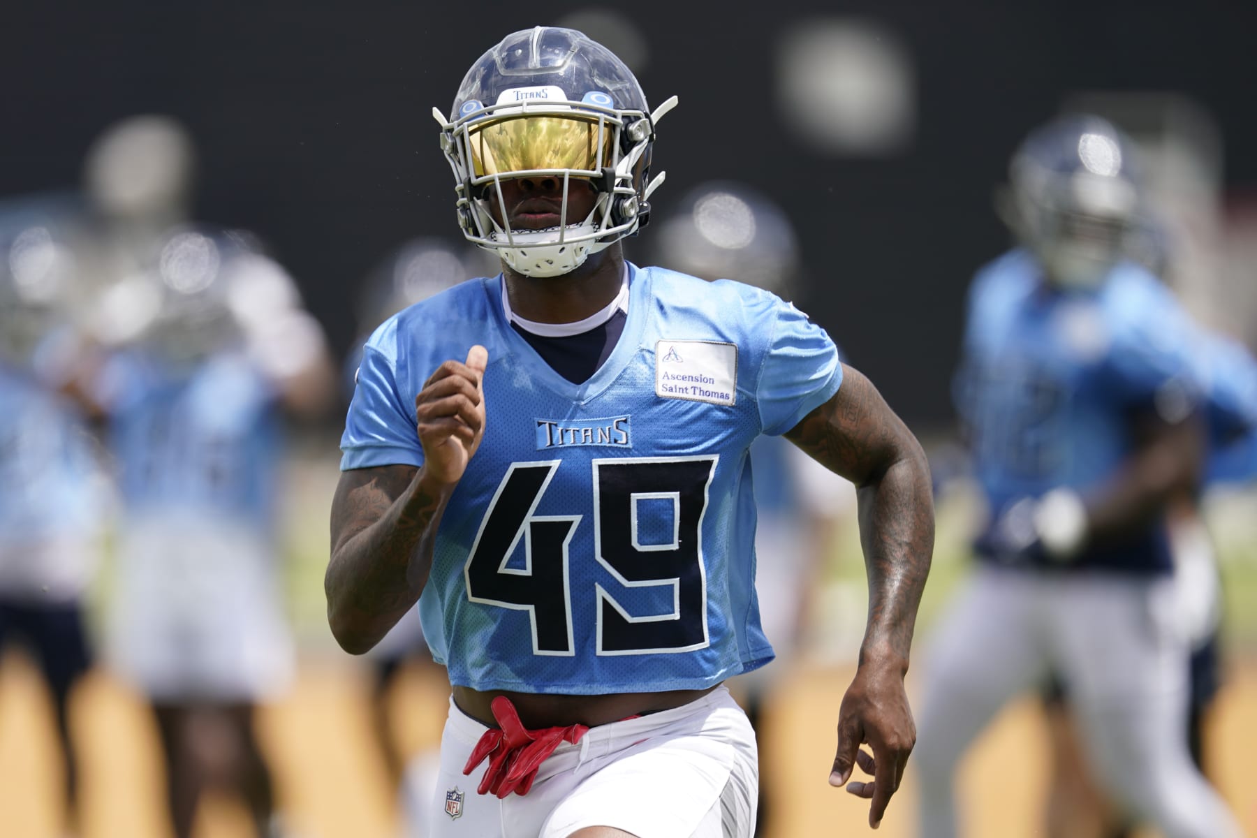 Tennessee Titans outside linebacker Arden Key (49) runs across the field during NFL football practice Wednesday, May 31, 2023, in Nashville, Tenn. (AP Photo/George Walker IV)