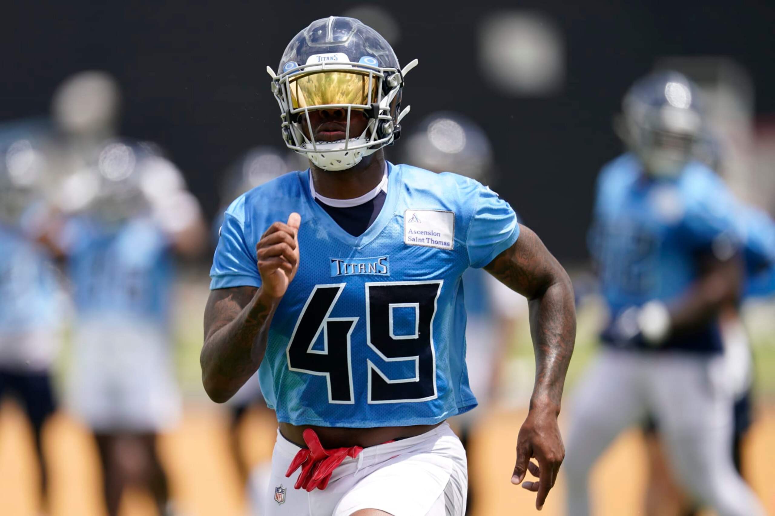 Tennessee Titans outside linebacker Arden Key (49) runs across the field during NFL football practice Wednesday, May 31, 2023, in Nashville, Tenn. (AP Photo/George Walker IV)