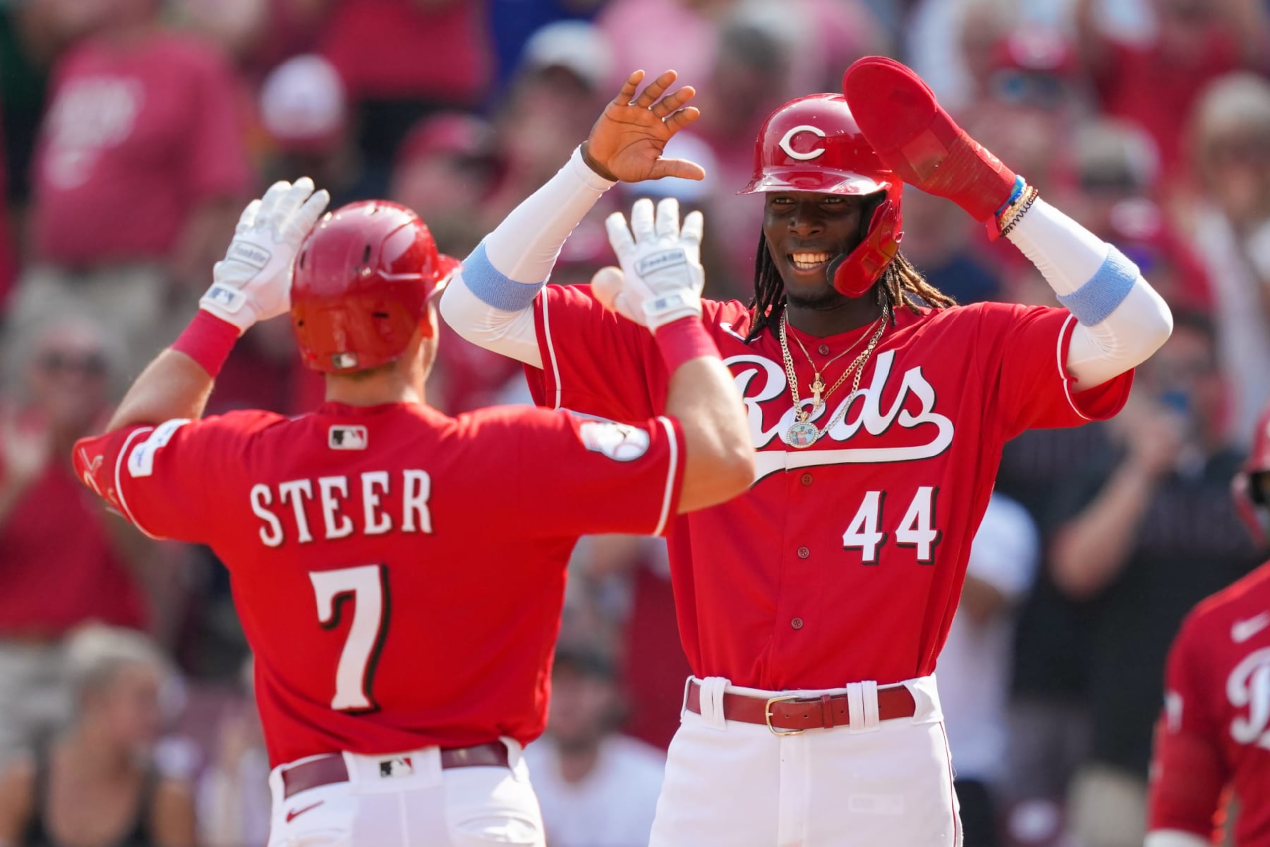 CINCINNATI, OHIO - JUNE 24: Spencer Steer #7 and Elly De La Cruz #44 of the Cincinnati Reds celebrate after Steer hit a home run in the third inning against the Atlanta Braves at Great American Ball Park on June 24, 2023 in Cincinnati, Ohio. (Photo by Dylan Buell/Getty Images)