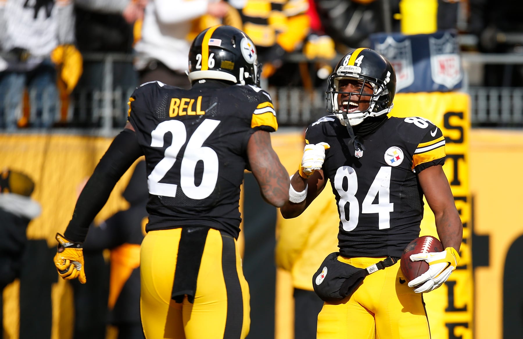 PITTSBURGH, PA - JANUARY 08:  Antonio Brown #84 of the Pittsburgh Steelers celebrates his touchdown with Le'Veon Bell #26 in the first quarter during the Wild Card Playoff game against the Miami Dolphins at Heinz Field on January 8, 2017 in Pittsburgh, Pennsylvania. (Photo by Justin K. Aller/Getty Images)