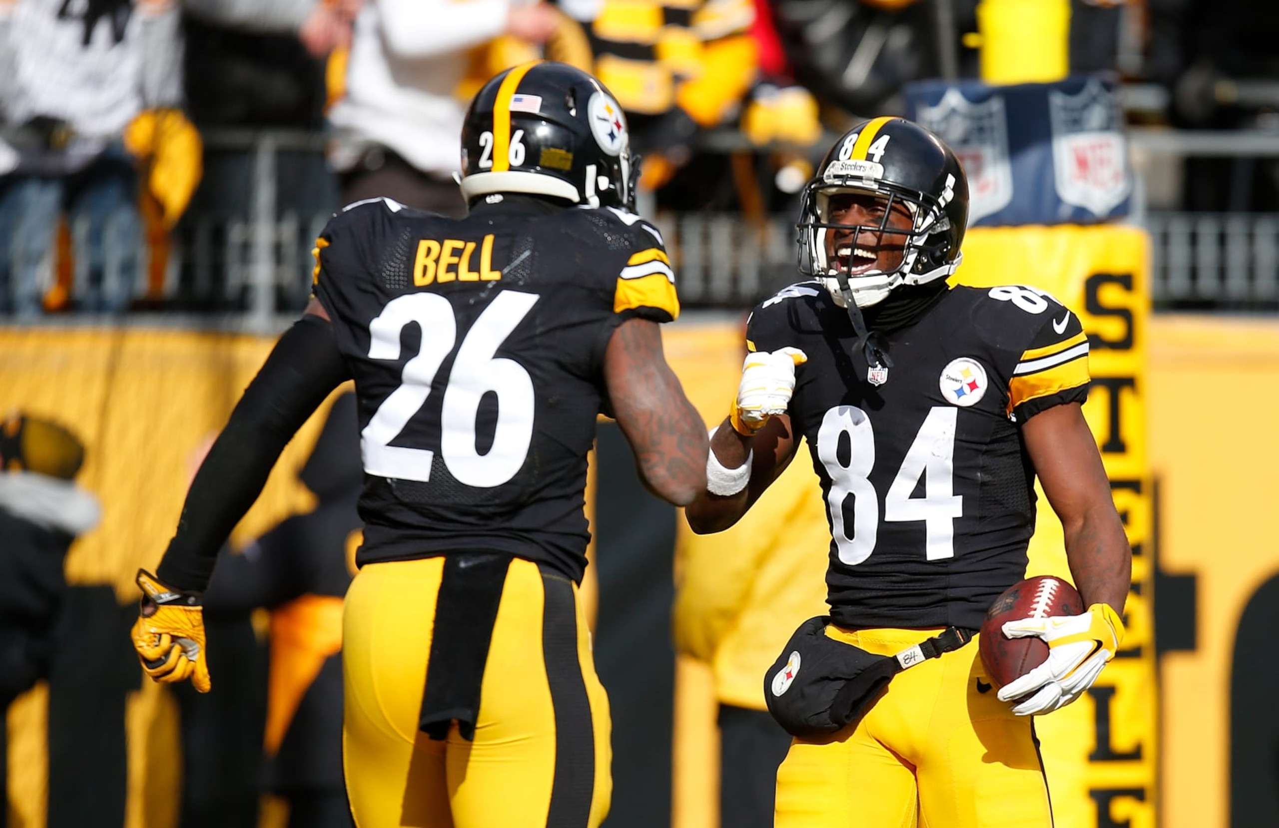 PITTSBURGH, PA - JANUARY 08:  Antonio Brown #84 of the Pittsburgh Steelers celebrates his touchdown with Le'Veon Bell #26 in the first quarter during the Wild Card Playoff game against the Miami Dolphins at Heinz Field on January 8, 2017 in Pittsburgh, Pennsylvania. (Photo by Justin K. Aller/Getty Images)