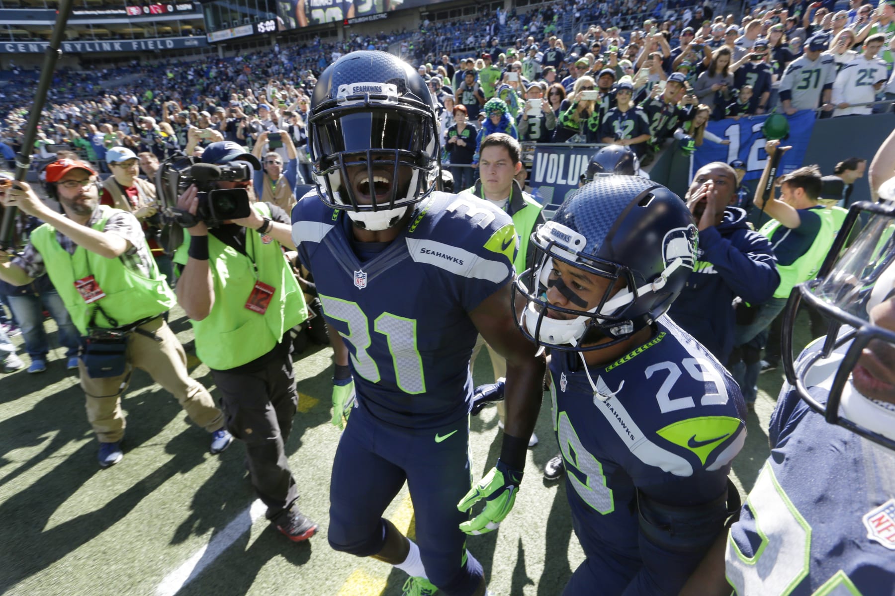 Seattle Seahawks strong safety Kam Chancellor (31) and free safety Earl Thomas (29) take the field before an NFL football game against the Chicago Bears, Sunday, Sept. 27, 2015, in Seattle. (AP Photo/Elaine Thompson)