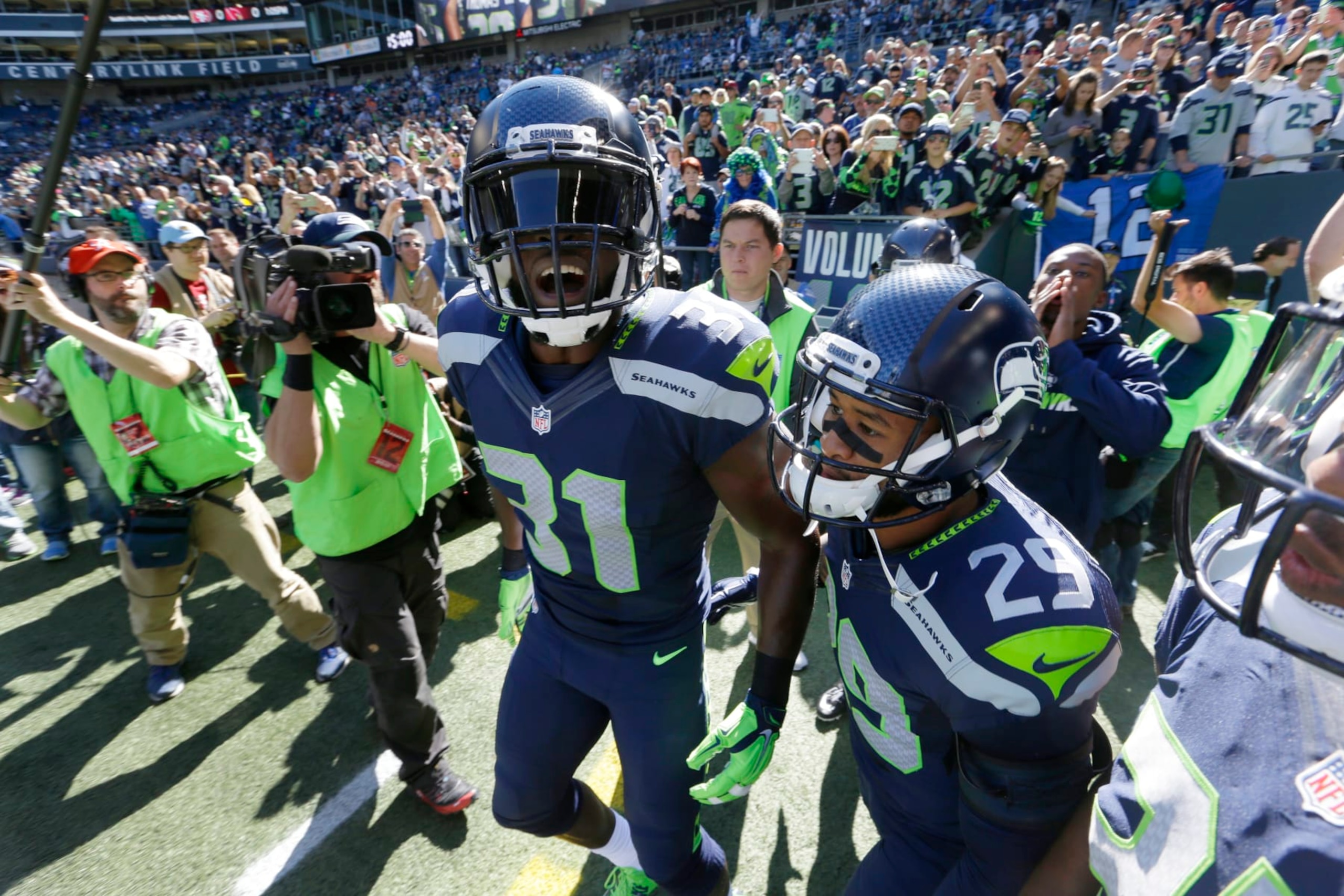 Seattle Seahawks strong safety Kam Chancellor (31) and free safety Earl Thomas (29) take the field before an NFL football game against the Chicago Bears, Sunday, Sept. 27, 2015, in Seattle. (AP Photo/Elaine Thompson)