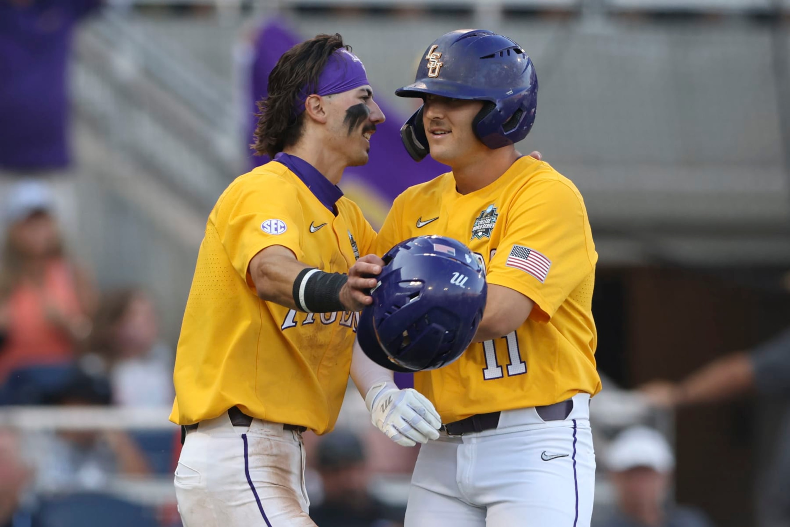 LSU's Josh Pearson (11) reacts at the plate with Jordan Thompson after after the two scored on his 2-run homer in the fourth inning of Game 3 of the NCAA College World Series baseball finals against Florida in Omaha, Neb., Monday, June 26, 2023. (AP Photo/Rebecca S. Gratz)