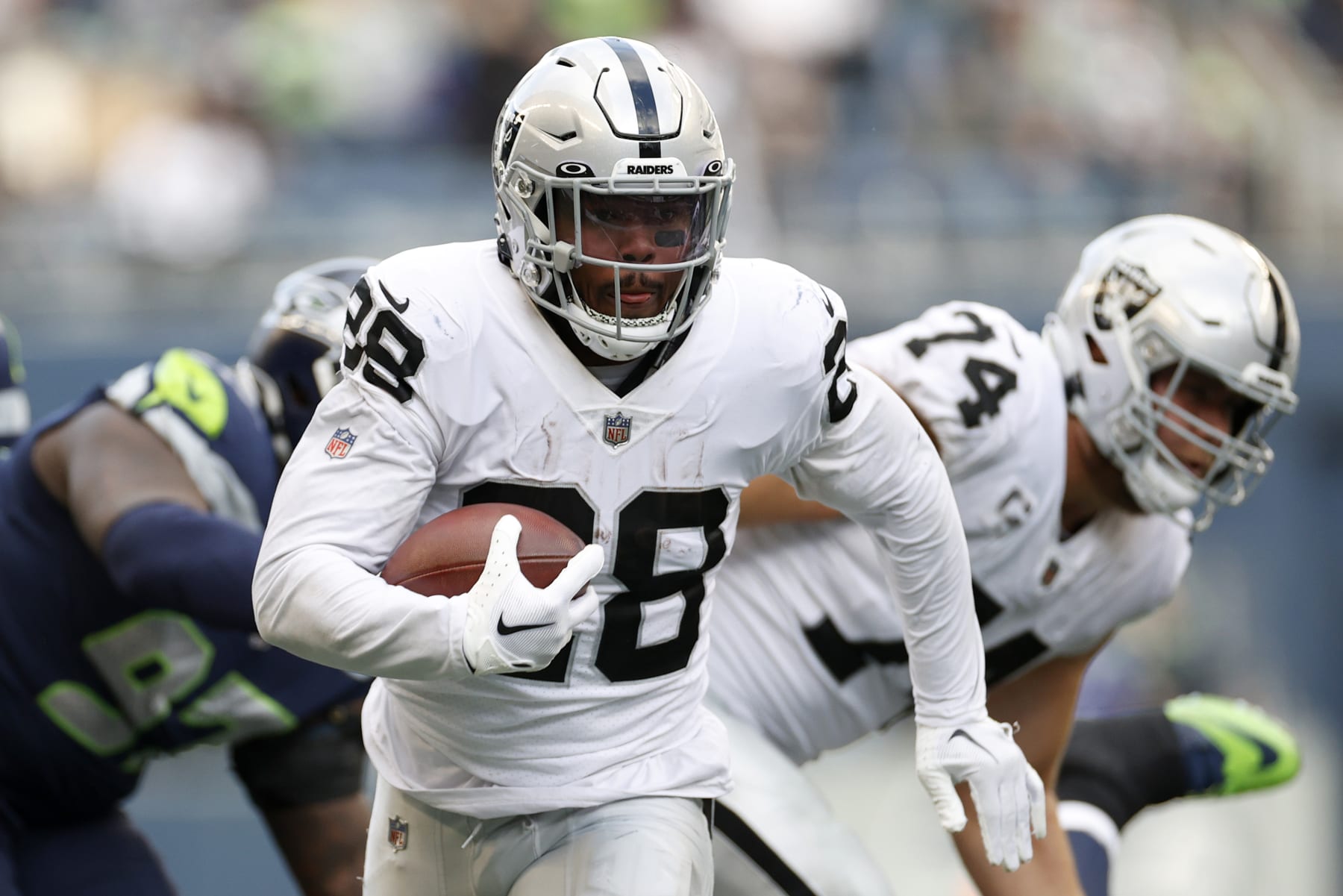 SEATTLE, WASHINGTON - NOVEMBER 27: Josh Jacobs #28 of the Las Vegas Raiders carries the ball during the first half against the Seattle Seahawks at Lumen Field on November 27, 2022 in Seattle, Washington. (Photo by Steph Chambers/Getty Images)