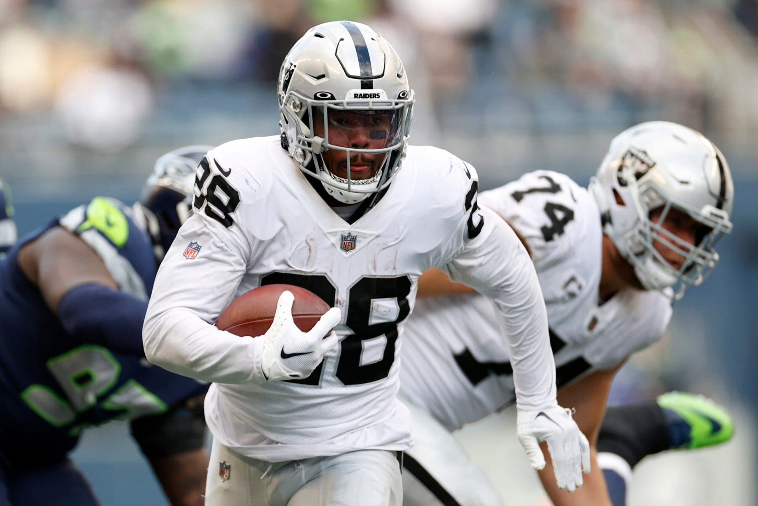 SEATTLE, WASHINGTON - NOVEMBER 27: Josh Jacobs #28 of the Las Vegas Raiders carries the ball during the first half against the Seattle Seahawks at Lumen Field on November 27, 2022 in Seattle, Washington. (Photo by Steph Chambers/Getty Images)