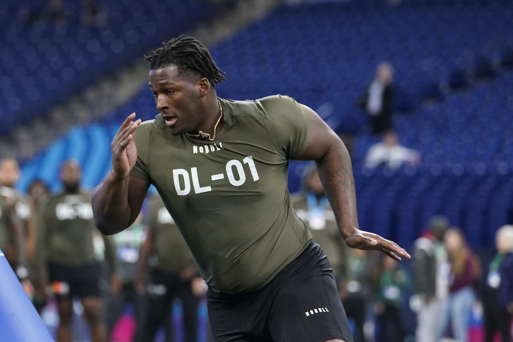 Wisconsin defensive lineman Keeanu Benton runs a drill at the NFL football scouting combine in Indianapolis, Thursday, March 2, 2023. (AP Photo/Michael Conroy)